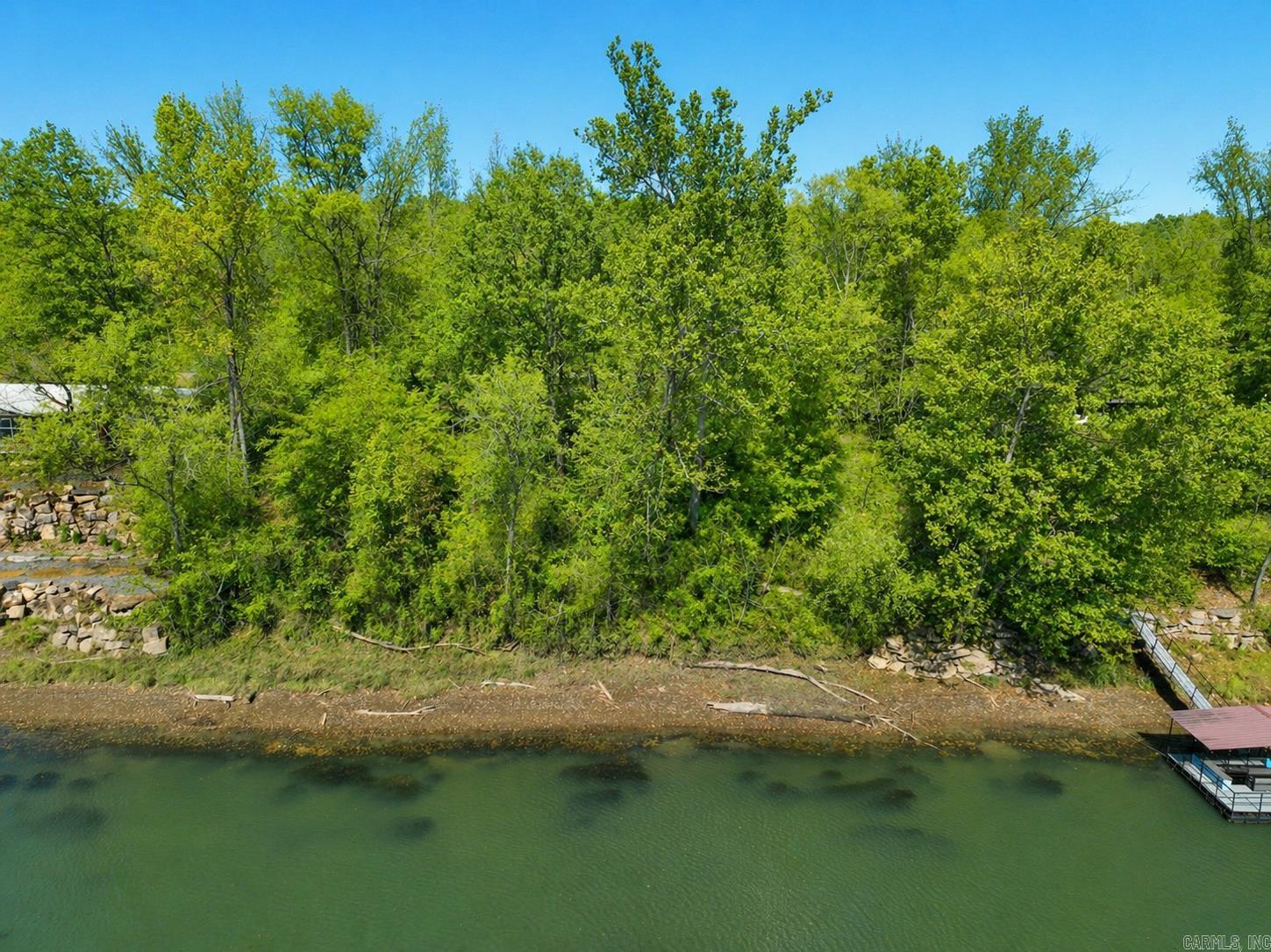 Primrose Creek Riverfront building lot located within a gated community of distinguished homes.  Lot contains 1.69 acres and approximately 134 ft of Little Red River frontage.  Ideally located near the community pool and shared amenities, yet privately positioned for a peaceful, undisturbed lifestyle.  Boat ramp dock, fishing pond, trails, and community sewer available.  1200 sf minimum build.  Premier setting for a custom home or private retreat with its own personal dock.  Agent see "showing remarks " for gate code.