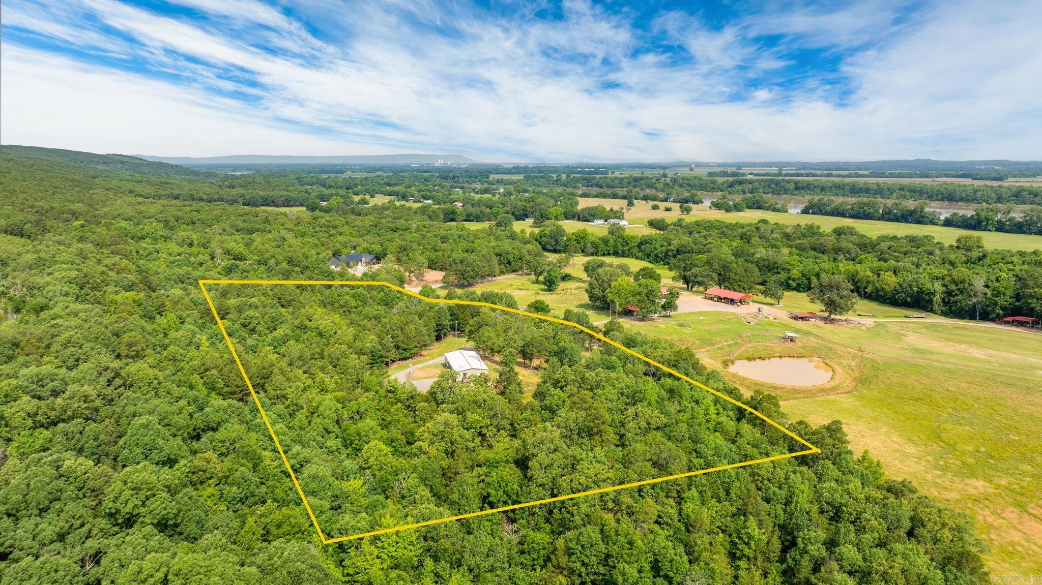 Like-New Home on 4.2 Acres – Minutes from Conway! Beautifully updated 3-bed, 2-bath home on 4.2 acres in Houston, AR. This open-concept floor plan features split bedrooms, LVP flooring, 8.5' ceilings with wood beams, and a stone fireplace with mounted TV that conveys. The kitchen offers a large island, walk-in pantry, stainless appliances, and a deep farmhouse sink. The spacious primary suite includes back deck access, a soaking tub, dual vanities, an 8' walk-in tile shower, and generous closets. Also, for added convenience this home has separate laundry/mudroom entry. Exterior highlights include a metal roof, wood shutters, LED accent lighting, a composite-covered back porch, and a fenced pet area. Concrete foundation, metal skirting, Peaceful setting just a short drive from Conway—move-in ready!