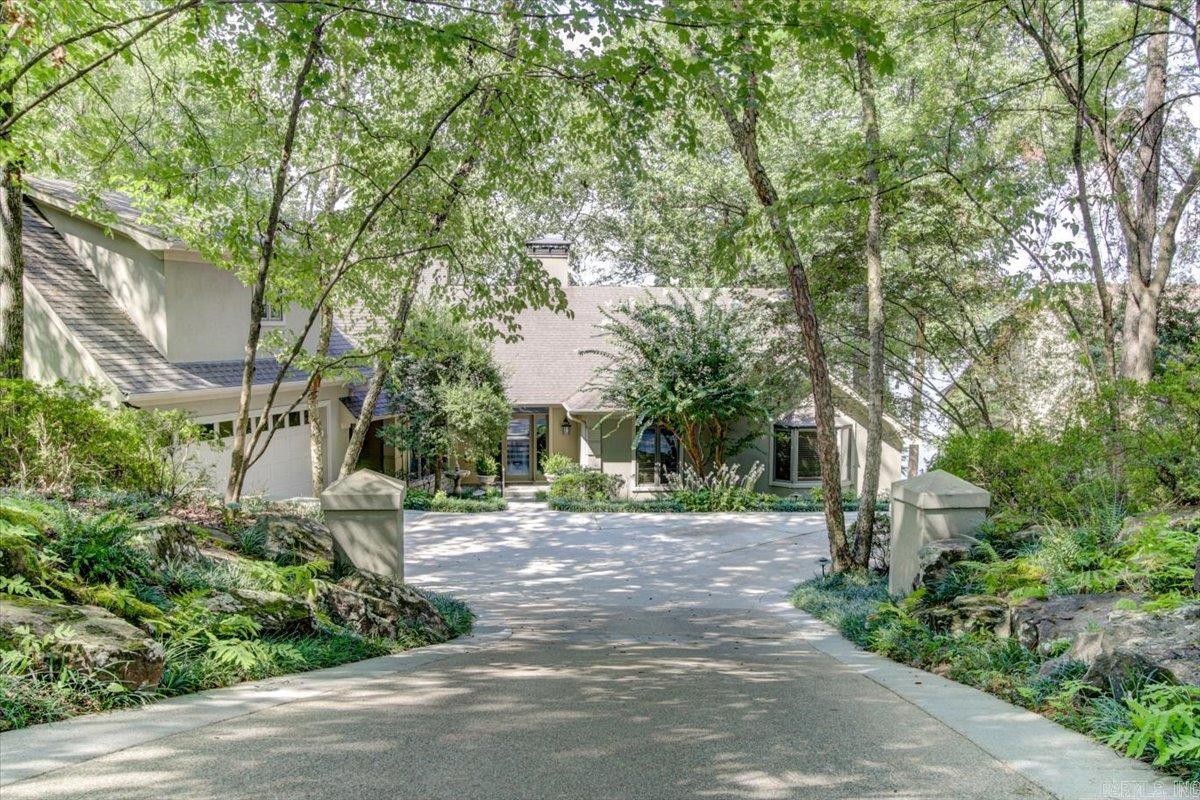 This custom built, 3854 sq ft, 3 bed, 3.5 bath home on Lake Hamilton has been meticulously maintained by the same family since it was built and is ready for a new owner. All 3 bedrooms are suites with private patios, sitting areas, and walk in closets. With North/South exposure on the lake, this home is protected from that brutal morning and afternoon sun. In addition to the home, nestled in exquisite landscaping for privacy, this property comes with 2 entire lots across the street complete with a fenced/gated 40'x80', 3200 sq ft, 1.5 bath building with air conditioned office and heated shop. What more could a family need?! Make your appointment to view this spectacular property today before it slips away. Square footage listed includes both house and shop.