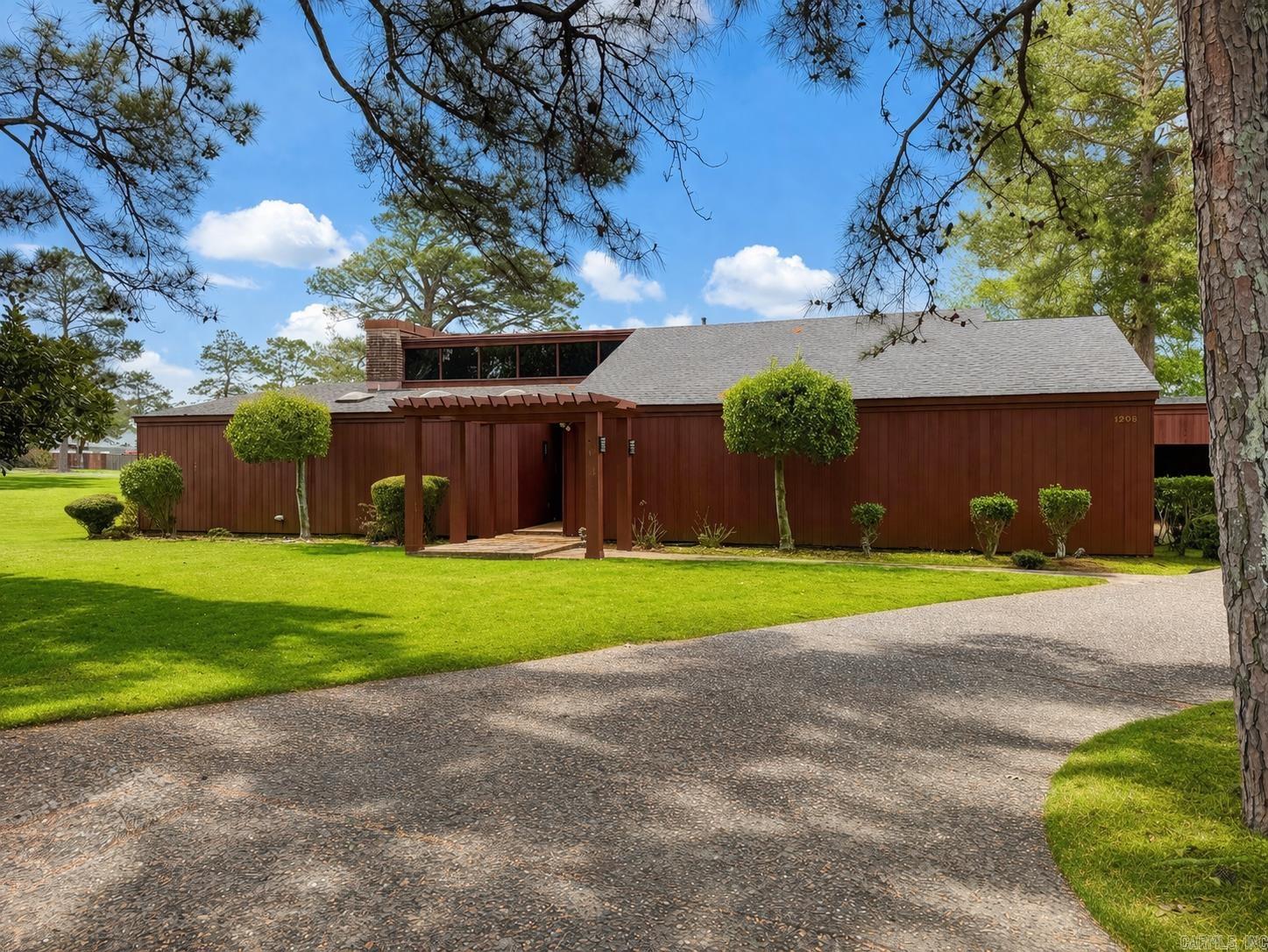 Experience a rare opportunity to own a one-of-a-kind architectural gem designed by Pine Bluff’s own renowned E. Fay Jones. This stunning 3-bedroom, 2.5-bath home is perfectly positioned along the 18th hole of the Pine Bluff Country Club, offering breathtaking golf course views and the opportunity to enjoy the club’s exceptional amenities right from your backyard.  Inside, the home showcases timeless design paired with thoughtful modern updates. The spacious living room is ideal for both relaxing and entertaining, while an additional sitting area provides a cozy retreat. The kitchen features a gas cooktop, convenient breakfast area, and flows effortlessly into the main living spaces. The layout includes a Jack and Jill bedroom setup, perfect for family or guests, along with a generously sized primary suite complete with ample closet space and abundant storage. Every detail reflects the architectural character and craftsmanship that make this home truly special. Located just two miles from Jefferson Regional Medical Center, this property combines convenience, prestige, and scenic beauty, making it a remarkable place to call home.