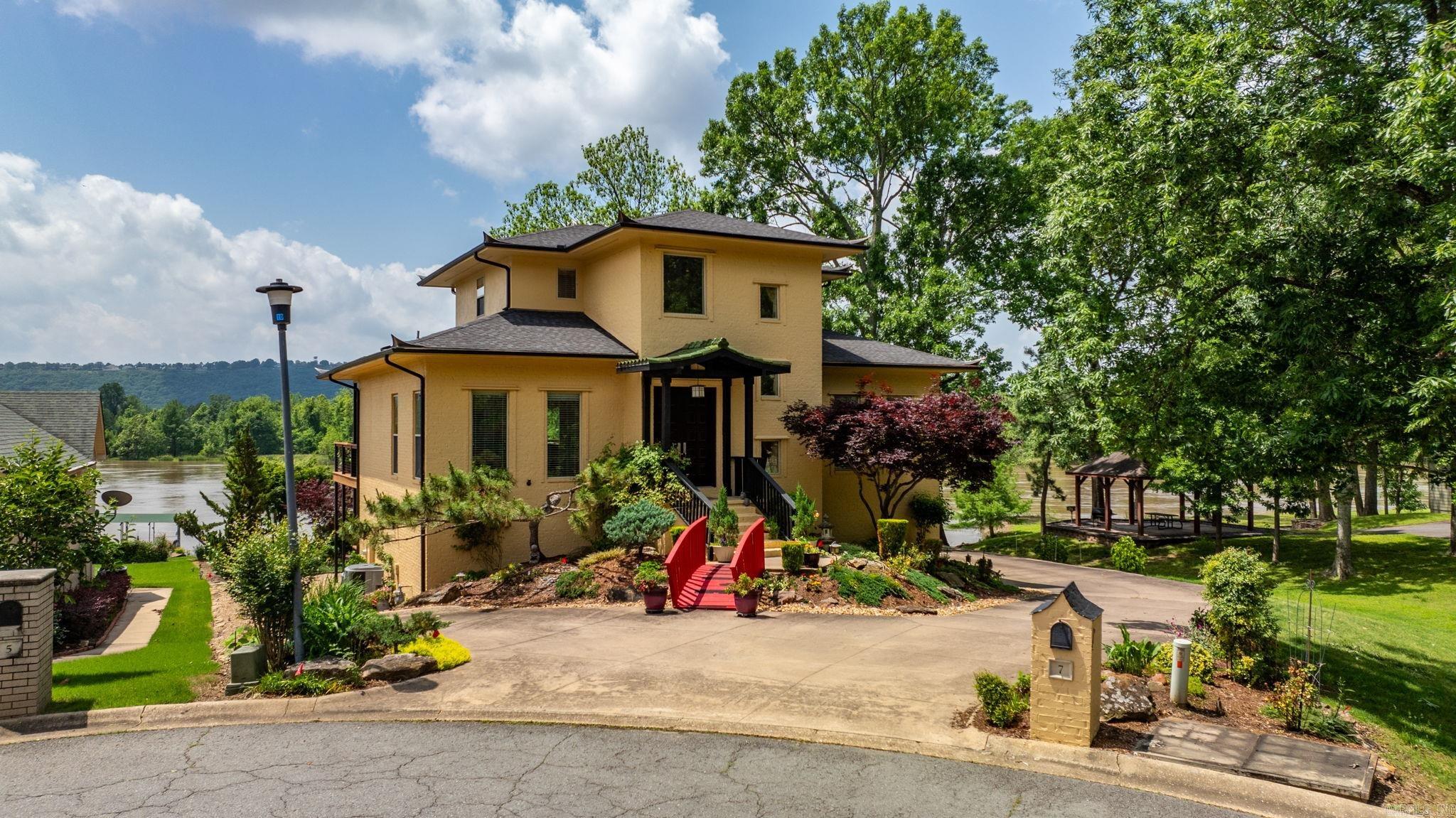 Welcome to this one-of-a-kind home in Maumelle! A uniquely designed home with a MILLION DOLLAR river view! This home invites in all the beauty of the Arkansas River and the gorgeous designs of the gardens that speak peace and tranquility. Soaring ceilings in the entry leads to a generous living area, custom kitchen with upper-end appliances and sleek finishes! Main level with office, formal dining and primary suite with luxurious bathroom with custom designs never seen before. Upstairs offers two bedrooms with full bath, lower level offers a guest suite with tub and separate walk-in shower. Private patio off guest room. Outside you can enjoy relaxing on the huge deck off the main level as you take in the evening sunsets. Other features include a sprinkler system, workshop, and so many extras! Stunning river views from the comfort of your home await you! SELLER IS VERY MOTIVATED!! Bring us an OFFER!!