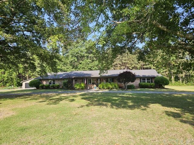 Nestled on 2.21 beautifully landscaped acres, this stunning rural property offers the perfect blend of comfort, space and outdoor living! Built in 1997 and featuring approximately 2,852 sq, this gorgeous home includes 3 bedrooms, 2 full baths, and 2 half baths with an inviting layout designed for both everyday living and entertaining.  Step inside and enjoy the warm welcoming living area highlighted by a beautiful gas log fireplace, formal dining room, spacious den area, and a large kitchen with abundant counter space, dimmer lighting, breakfast bar. The kitchen updates- dishwasher (2018), refrigerator (2022) and gas stove (2023).  The home feature a convenient laundry room/washroom area and large pantry.  Outside, you will fall in love with the backyard oasis that features a fenced inground pool, with liner less than 4 years old, outdoor TV and the Big Green Egg that also remains with the property- perfect for entertaining family and friends. A built-in bug sprayer system around the pool areas help keeps the insect away so you can enjoy your outdoor space comfortably all season long.  Generator, Corner Lot, Detached 2-car garage and so much more.  New Heat/Air 2023, New Windows