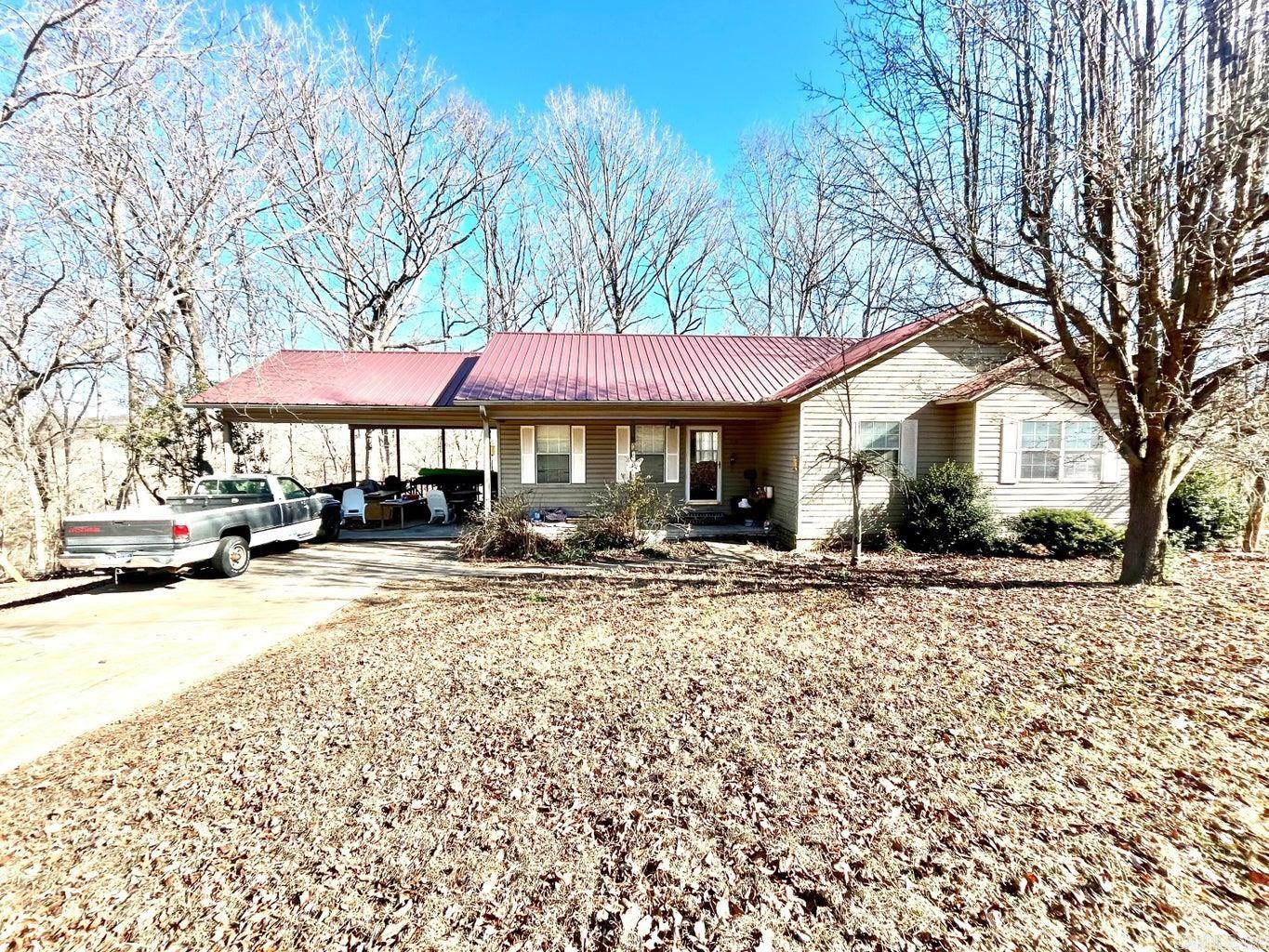3BR 2BA CHARMER!! Escape to this quiet, established neighborhood with beautiful mountain and forest views! Inside you will find a well-flowing layout providing ample living space. Relax in the large primary suite featuring a walk-in closet and a private bathroom. This home is designed for easy living, featuring a low-maintenance brick and vinyl exterior, as well as a durable metal roof. The 2-acre lot ensures plenty of space between neighbors and room for imagination. Invision sipping a morning coffee or a cold tea on your back deck while you enjoy stunning views of nature and local wildlife. The seller is offering a $5,000 allowance for flooring and paint with an acceptable offer—bring your vision and customize this home to your exact style! Combining peaceful country vibes with city  convenience, this property is a rare find that is ready for your personal touch. Schedule your showing today and see the potential for yourself!