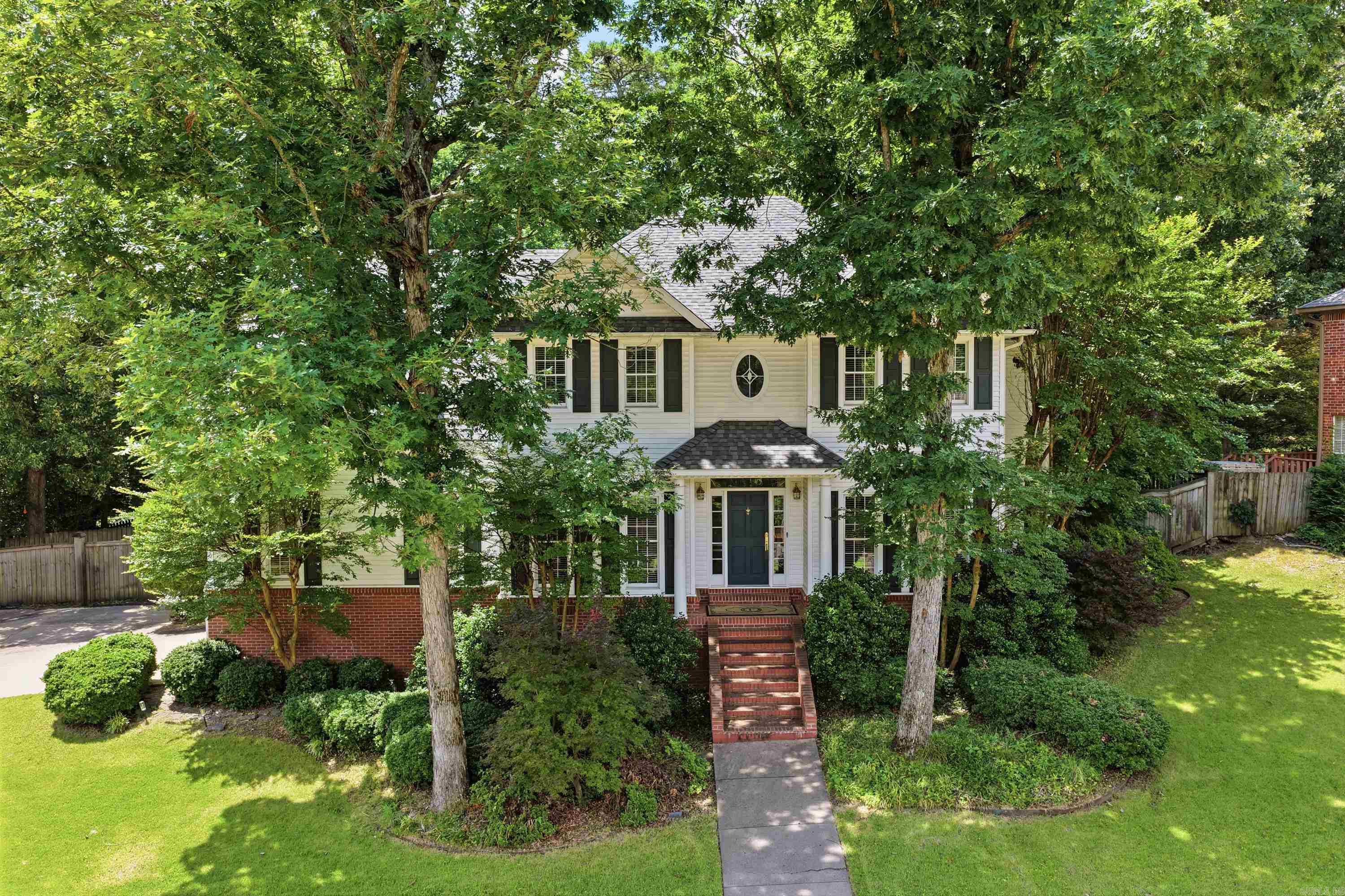 This classic Colonial has everything that makes the style timeless — and everything that makes buyers actually want to live there. The kitchen was done right: quartz countertops, gas range, double convection ovens, a Samsung Smart refrigerator, and two walk-in pantries. Formal dining and a generous living room give you real space for real life. The layout upstairs is one of the best features. The primary suite anchors one end. Two bedrooms with a Jack-and-Jill bath sit in the middle. On the far end, a large bedroom with its own ensuite works perfectly for guests, in-laws, or whoever needs their own space. Fresh paint, updated lighting, new hardware, modern fixtures — the finishes are clean and consistent throughout. Outside, the deck overlooks a fully fenced backyard. The side-loading garage keeps the front elevation clean. The big-ticket items are already done: new roof in 2024, whole-home generator, and a Vivint security system with cameras and thermostat control. Carriage Creek's community park has a private pond, full tennis court, two pickleball courts, and a half basketball court.