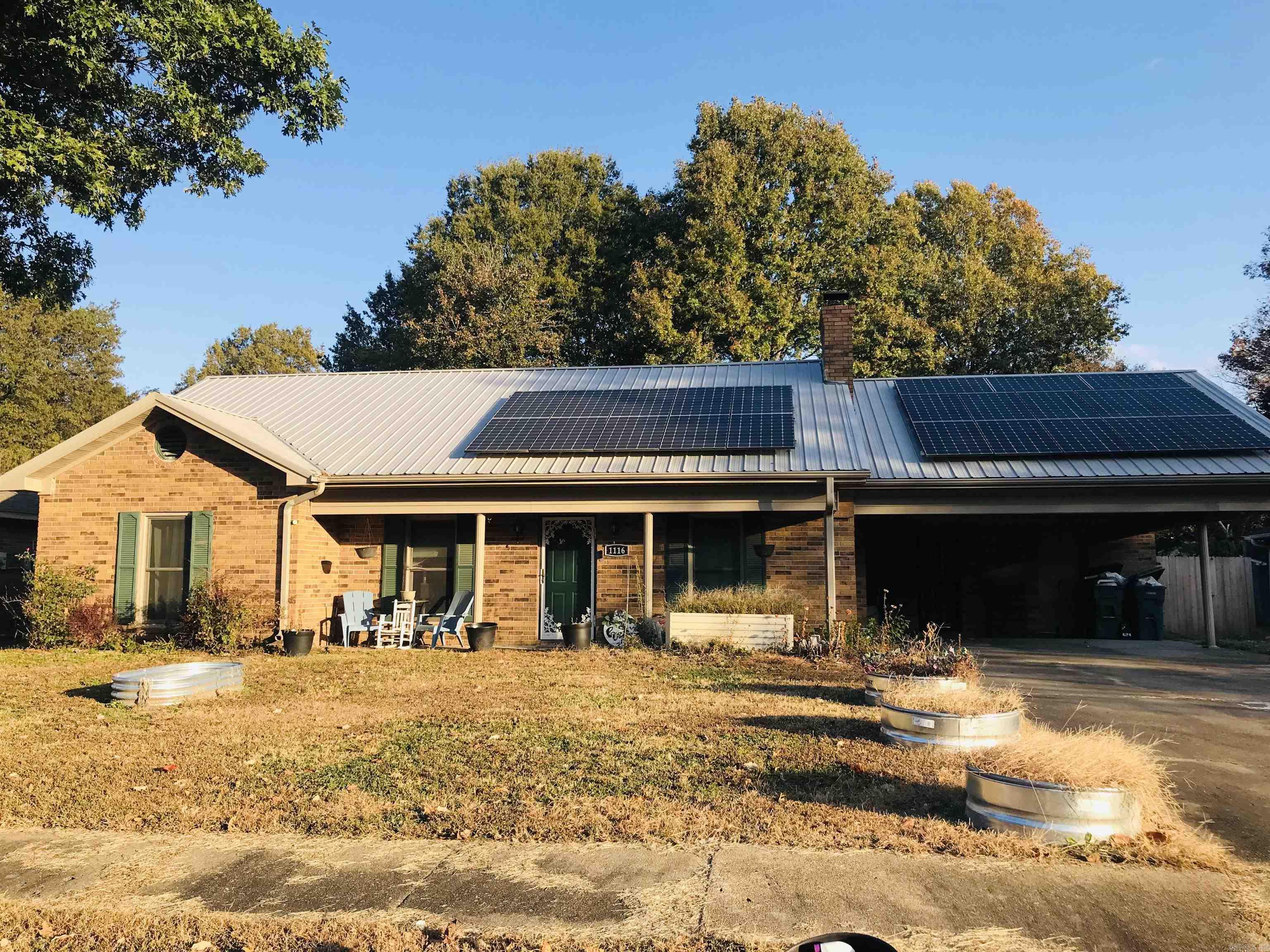 Nice 3 bedroom, 2 bath home two blocks from the hospital and also near schools. This is an all electric home that also has solar panels installed on the roof. Seller is willing to remove them at closing or Buyer can assume the existing loan, (15 years remaining), for the panels. The living room has a fireplace with a wood burning insert that will keep the house warm during the winter months. Beautiful wood laminate has been added throughout the home while the eat-in kitchen has nice ceramic flooring. There is a separate laundry area situated just off the kitchen/breakfast room with exit to the carport. While this is an all electric home, natural gas is available should a new homeowner decide to utilize it. There are several updates that has been made to the home, one of which is a new metal roof installation. The backyard has a wood privacy fence making a safe place for kids and pets.