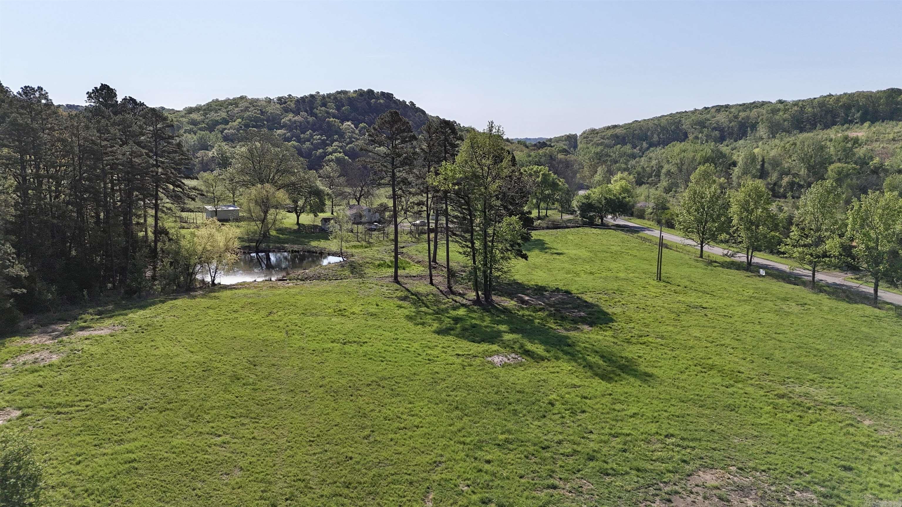 Discover this surveyed 7.79 +/- acres on Mill Creek Road, blending convenience with country charm. This scenic property features a pond, fencing, and a gated entrance with generous road frontage, and has utilities available at the road for easy development. Ideally located just 10 miles from ATU, 6 miles from Lake Dardanelle boat ramp, and 7.7 miles from ANO, you’ll enjoy rural tranquility without sacrificing accessibility. Perfect for building your dream home, creating a private retreat, or investing in land with endless potential. Experience peaceful living close to town, fishing, boating, and outdoor recreation. Don’t miss this opportunity to own your own slice of countryside paradise!
