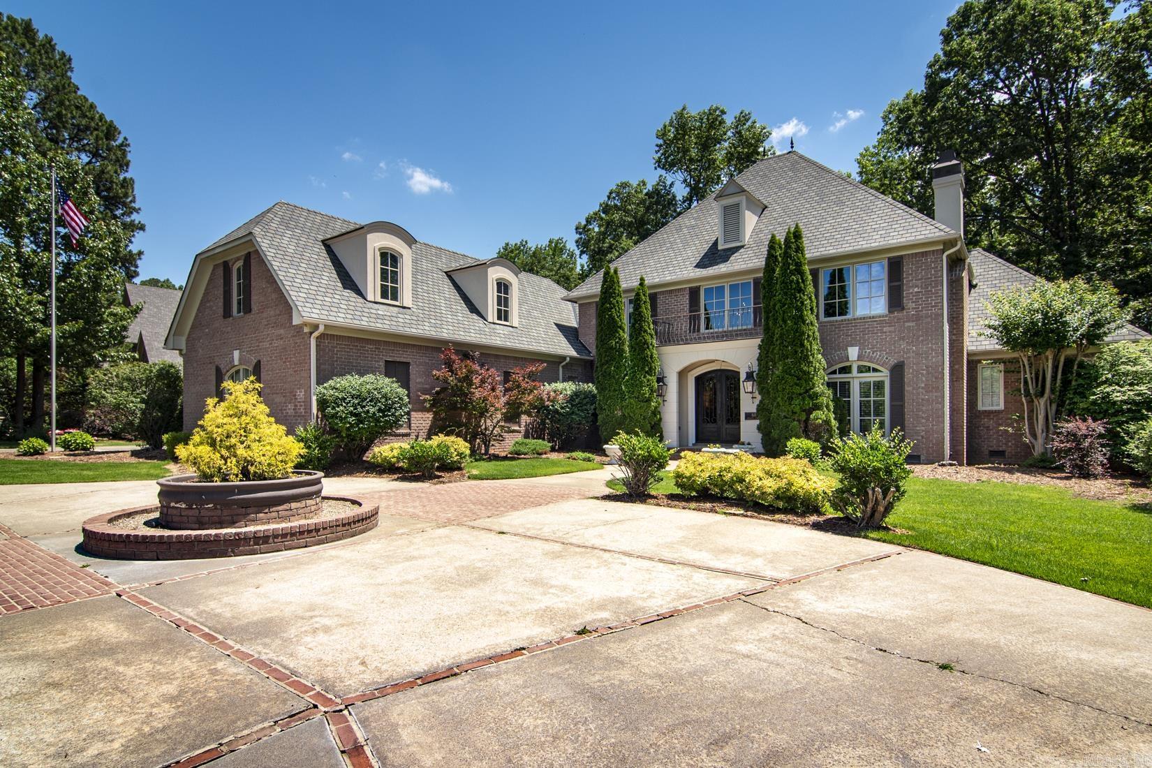 Exceptional Custom Home by Carl Gray Hinson in Prestigious Sologne Nestled on a beautifully landscaped, three-quarter-acre corner lot, this outstanding custom home is located in Sologne—one of Chenal’s most sought-after neighborhoods. Backing up to protected greenspace, this residence offers privacy, elegance, and timeless architectural design. The gracious main level features two spacious living areas, a formal dining room, and an eat-in kitchen perfect for entertaining or casual gatherings. The luxurious owner's suite is a true retreat, complete with a spa-like bath for ultimate relaxation. Upstairs, you’ll find three generously sized bedrooms, a large recreation room, and a versatile bonus room ideal for a home office, gym, or hobby space. Enjoy serene views from the wonderful, covered porch that overlooks the lush greenspace, offering a tranquil outdoor living experience. Additional highlights include a three-car garage with extra storage space and meticulous landscaping throughout the property. Opportunities to own a home of this caliber in Sologne at this price point are rare—don’t miss your chance to make it yours.  Property has invisible fencing for pets.