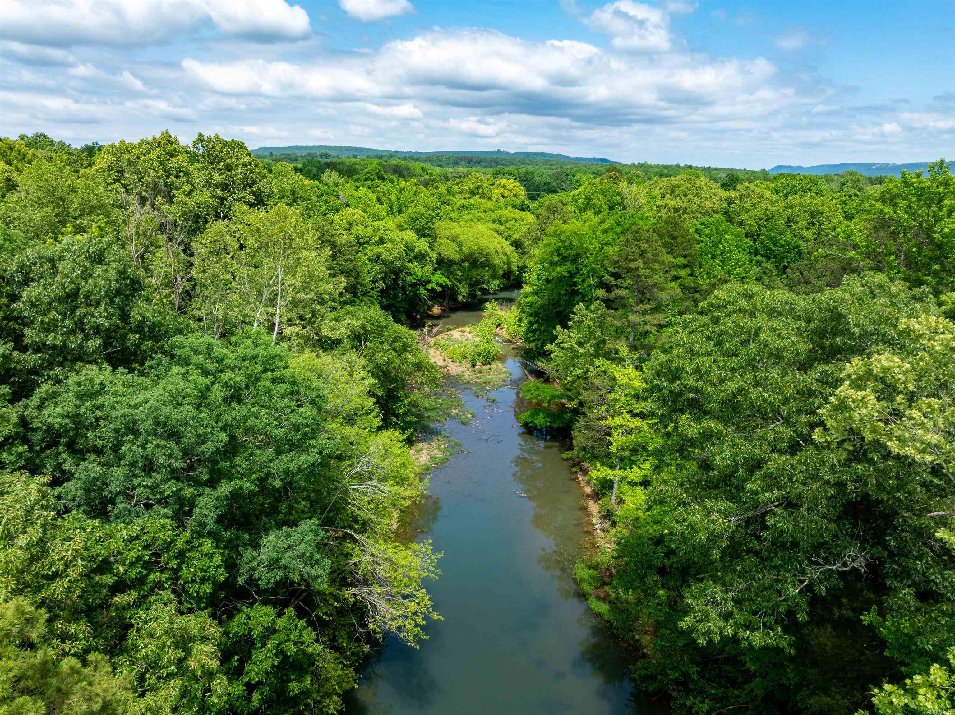 Wooded acreage right in Choctaw with power pole on site, water nearby, no restrictions, mature pine and hardwood timber, and a beautiful year-round creek running along the south end of the property. Whether you're looking to build your dream home, develop multiple homesites, create a recreational retreat, or invest in land with future potential, this property offers endless possibilities. While the property does have a corner touching the highway, the primary access is from a private drive, providing added privacy and a peaceful setting. The combination of timber, water features, wildlife habitat, and convenient access makes this a rare find in the area. Enjoy the benefits of country living while remaining just minutes from Choctaw Marina, Greers Ferry Lake, and all the outdoor recreation the area has to offer, including boating, fishing, kayaking, and hiking. With gently rolling terrain, natural beauty, and plenty of room to spread out, this property is ready for your vision. Properties with creek frontage, marketable timber, utilities available, and no restrictions are becoming increasingly difficult to find. Minerals are negotiable.