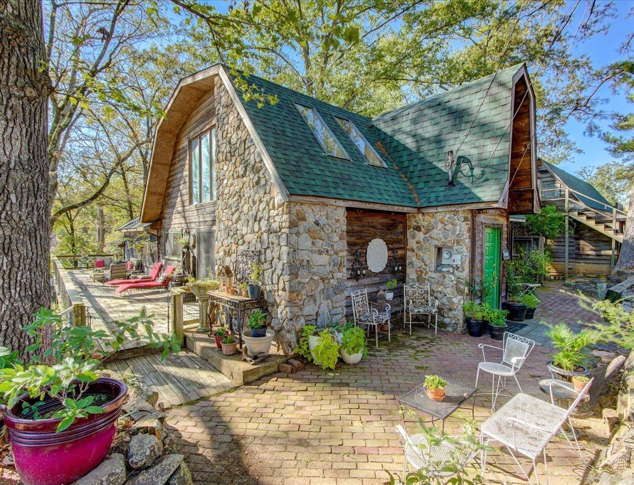 Multi-family Lake Hamilton lakefront opportunity! On approximately .75 acre of land, this property offers breathtaking lake views, a wrap-around deck, and a serene park-like setting.  Multiple lots.   This unique property includes two homes and three rental opportunities:  1. **Main House:** A charming 3-bedroom, 2.5-bath single-family cottage type home 2. **Duplex:** Featuring a 2-bedroom unit downstairs and a 1-bedroom unit upstairs, each with separate entrances. 3. **A vacant lot:** With Lakefront Access  Well-cared-for, character-filled properties.  Excellent location.  Centrally located in a highly sought-after area.    Stunning lake views, income property, and a perfect location.