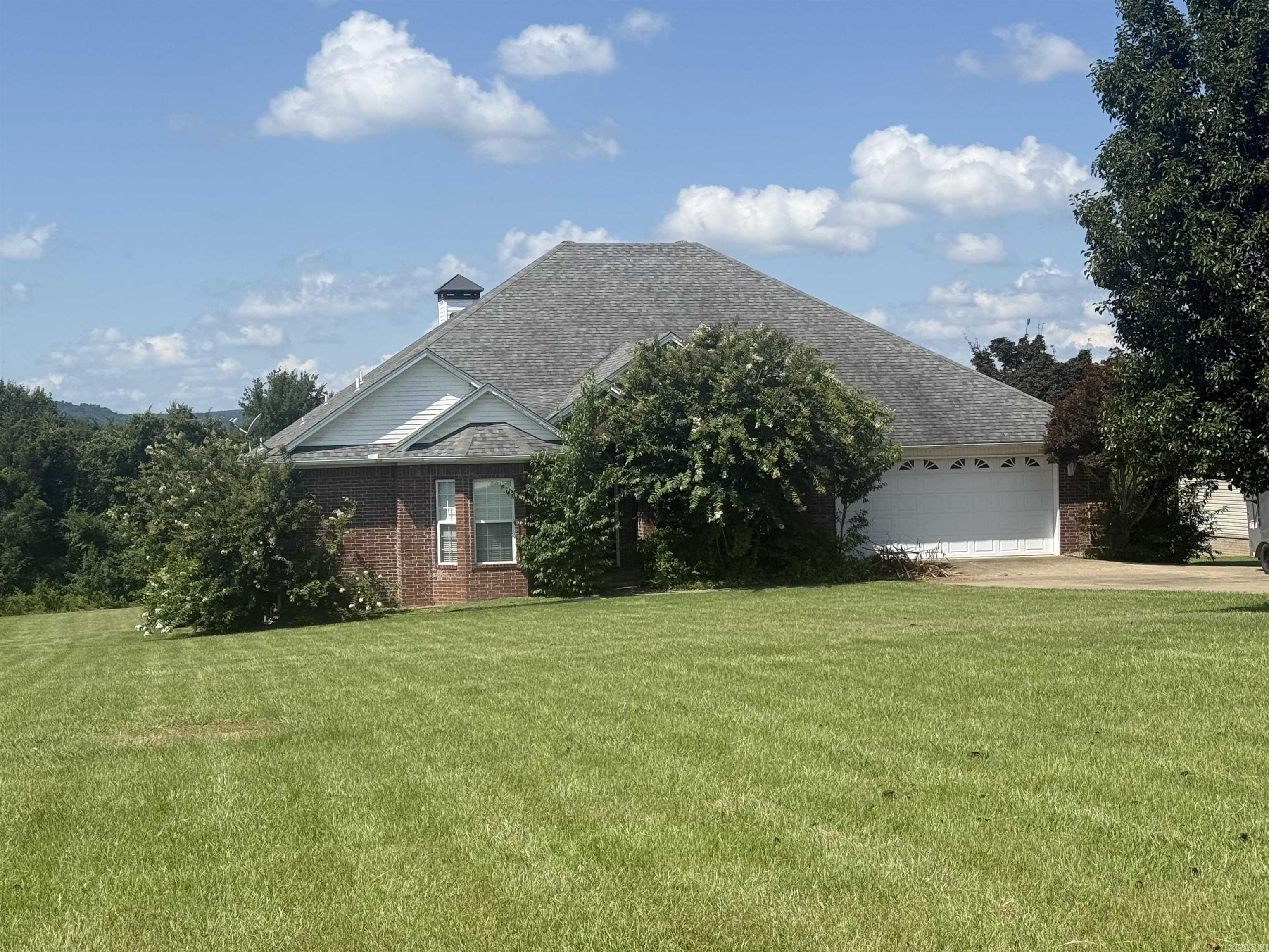 Welcome to this almost 3,000 square foot partially furnished brick home in a beautifully maintained gated community, where manicured grounds, a picturesque neighborhood pond, and breathtaking natural surroundings create an exceptional place to call home. Enjoy lakefront living with a partial lake view, a gentle path leading from your backyard to the water's edge, and the majestic mountains providing a beautiful backdrop.  Inside you will find spacious living areas designed for comfort and entertaining. The expansive game room is a standout feature, complete with a pool table that coveys with the home, making it ready for game nights from day one!  The game room also has wet bar and mini fridge, ready for entertaining. The home has 2 HVAC units. The main unit for the house was replaced in 2024 and the other unit is dedicated to the bedrooms. A portion of the garage was used for the addition of the large game room. The remaining garage space contains the in-ground storm shelter and has enough room for storing 2 golf carts or side by sides.  The owner plans to have the shrubs trimmed and landscaping updated soon.  Call me and take a look!