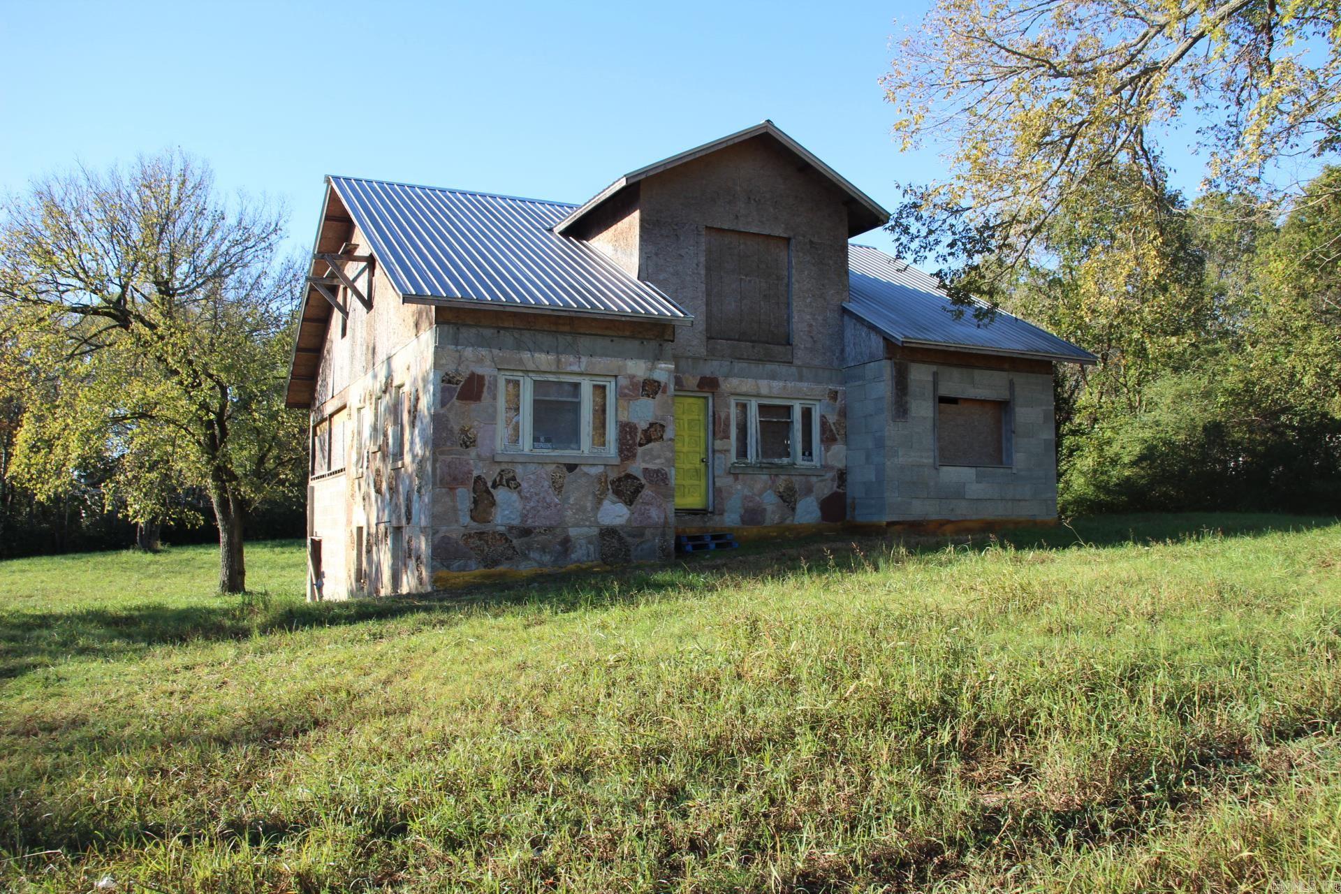 Fixer upper in town with tons of potential. This stone home could be designed to any floorplan you choose. Currently there is some interior framing to make a 3- or 4-bedroom home, but you can make it what you want. There is a main level a partial basement with garage area and an upper level. Main level has 1886 sq ft and another 1886 on upper level and approx. 900 sq ft in the basement that could be finished out. This home could be a real showstopper and sits on two level lots totaling .89 of an acre. Sq. ft. is not heated or cooled.