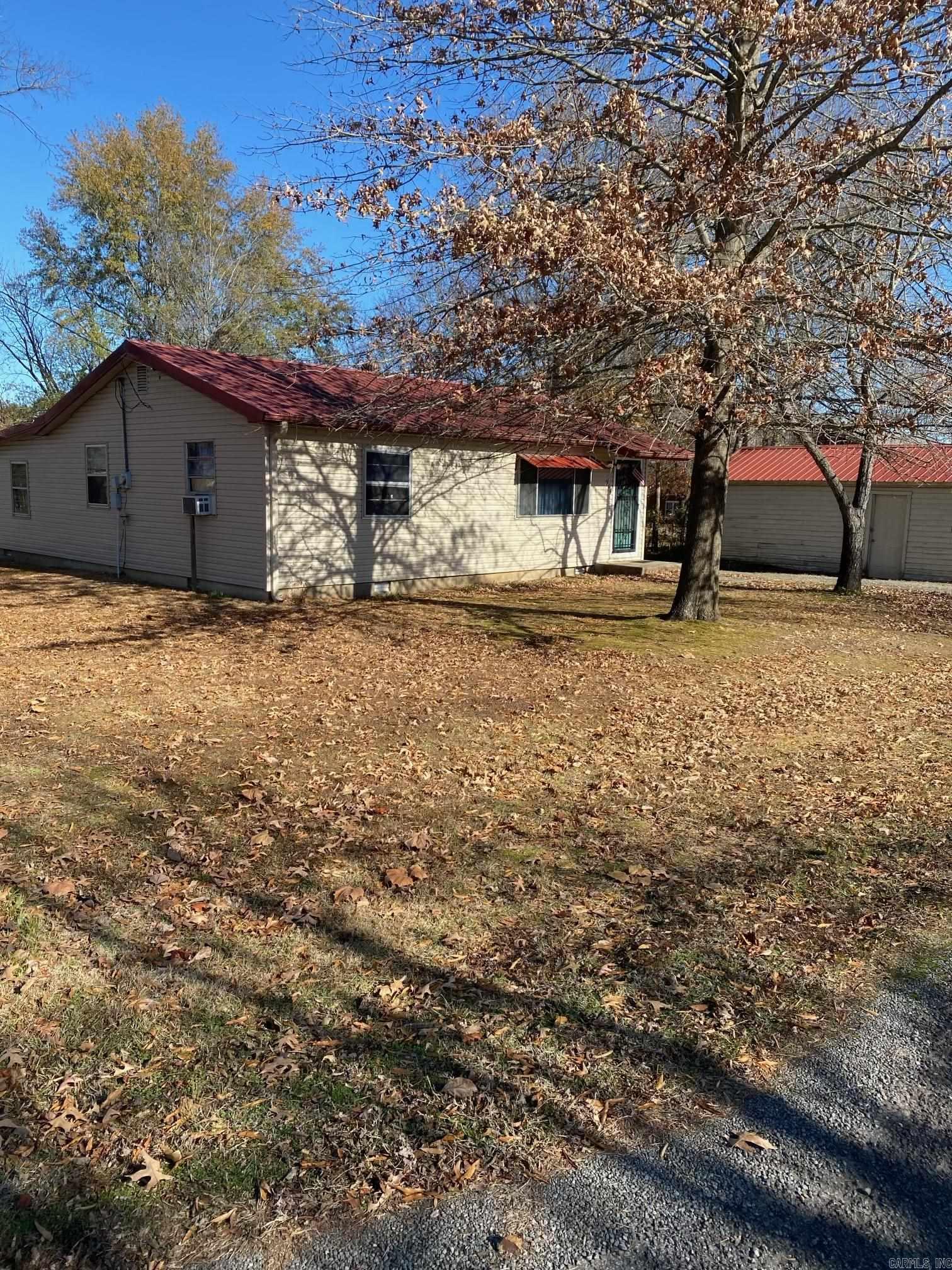 Corner lot with two entrances that make a circle drive. Over the years the owners have updated to a metal roof, put in insulation, put on new crawl space door access, new outside siding, and put in some updated plumbing, and added gravel to name a few.  One of the bonus rooms is not finished but it has heat and air like the rest of the home.  It has city water, city sewer and natural gas.  Don't miss this cute home.  It is ready to move into now to live in.  The little Shop has electricity and well water inside with concreate floors.  The outside of the shop can use some tlc.  Note the owners are selling the home as is.  The square footage includes the unfinished room with roof coverage and utilities in it.