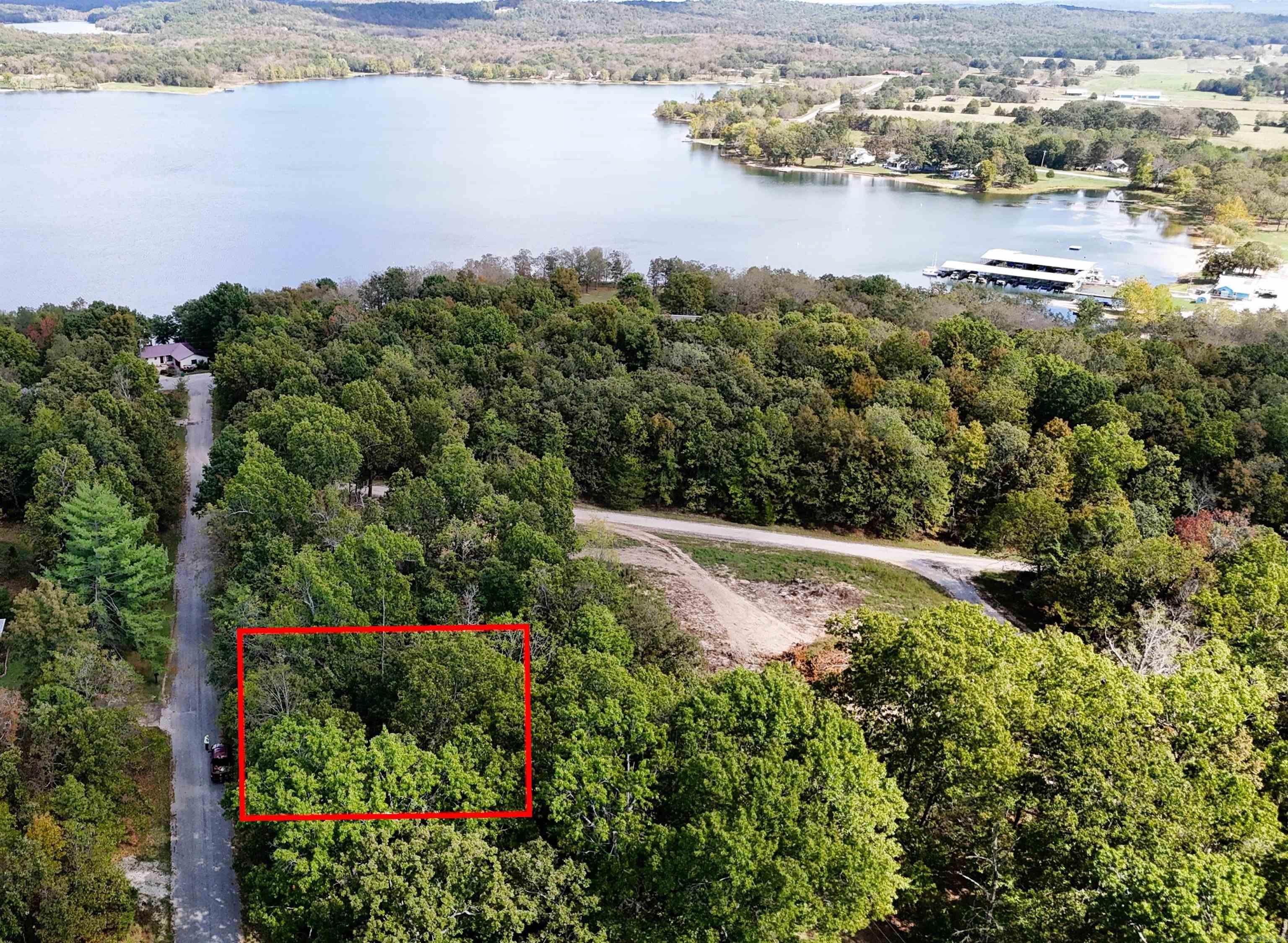 0.37 Acres vacant, charming-wooded lot with paved road access, near Crown Lake, Horseshoe Bend Beautiful vacant lot within minutes of the scenic Crown Lake. Perfect spot to build your getaway or dream home. Peaceful, established neighborhood in Horseshoe Bend with nature all around. Ideal for a vacation retreat, retirement home, or investment. Electricity and water are available.