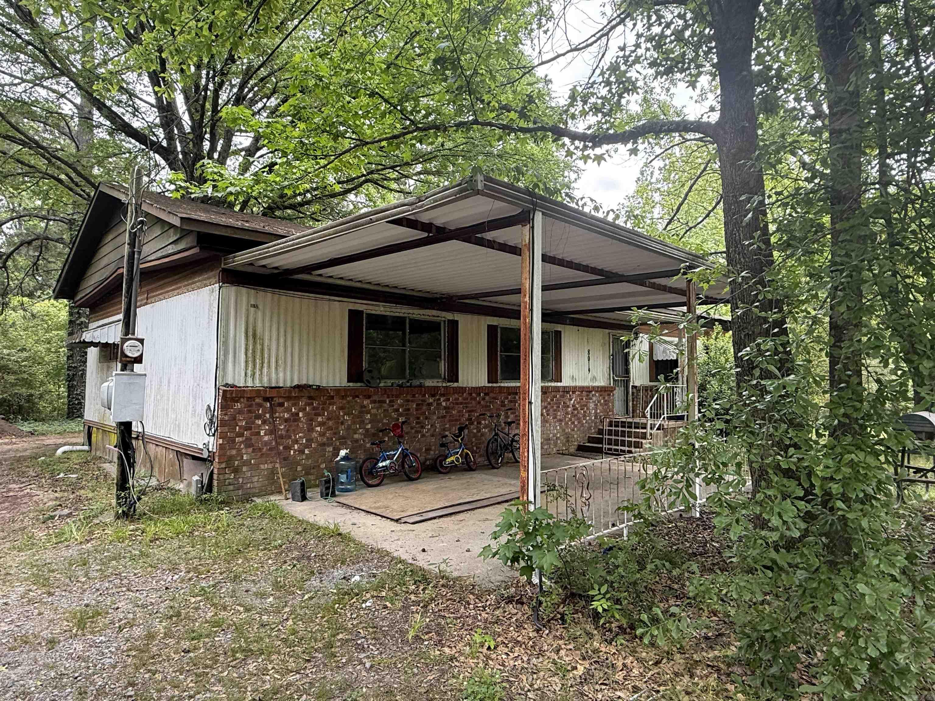 Unleash your imagination on 7 expansive acres!  This rare Little Rock find offers the perfect blend of space and opportunity.  The property features two structures- a 1.200 sq ft (3Bed/2bath) mobile home and a secondary 432 sq ft (1 Bedroom/1 bath) unit- both awaiting a complete reimagining or a fresh start. Whether you are looking to build your dream estate, renovate, or create a multigenerational homestead, this acreage provides the ultimate foundation. Bring your creativity and your contractor to transform this vast space into your personal sanctuary.   Property is being sold "as is", structures are only accessible with the owner present.   the structures have been vacant for quite some time. No known issues however please wear a mask.