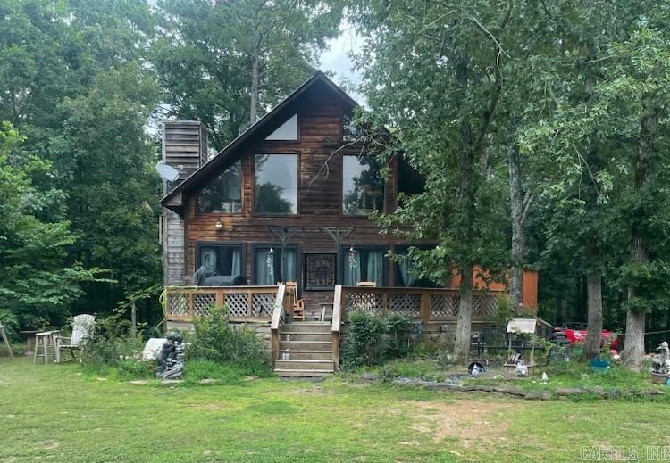 Your very own Cabin near the Lake!  Nearby Neighborhood Access to Greers Ferry Lake! This lovely wood sided cabin is what everyone dreams of when they think of a Cabin in the woods!  The woodwork, stone fireplace, wall of windows, outdoor decks and exterior rock work stand apart.  The space inside, while not large, is laid out in a very functional way giving you 3 bedrooms/2 bathrooms, a separate dining area and utility room.  There are lovely wood french doors to the kitchen that has been recently updated and lovely loft bedroom that really stands out.  Exterior storage sheds to put all of your water toys... Sitting in an area of like properties, and so convenient (about 30 minutes drive) to Clinton or Heber Springs. Some maintenance items are needed, but at this price point, it will be hard to beat! This is worth taking a look at!  Appointment Only to view.
