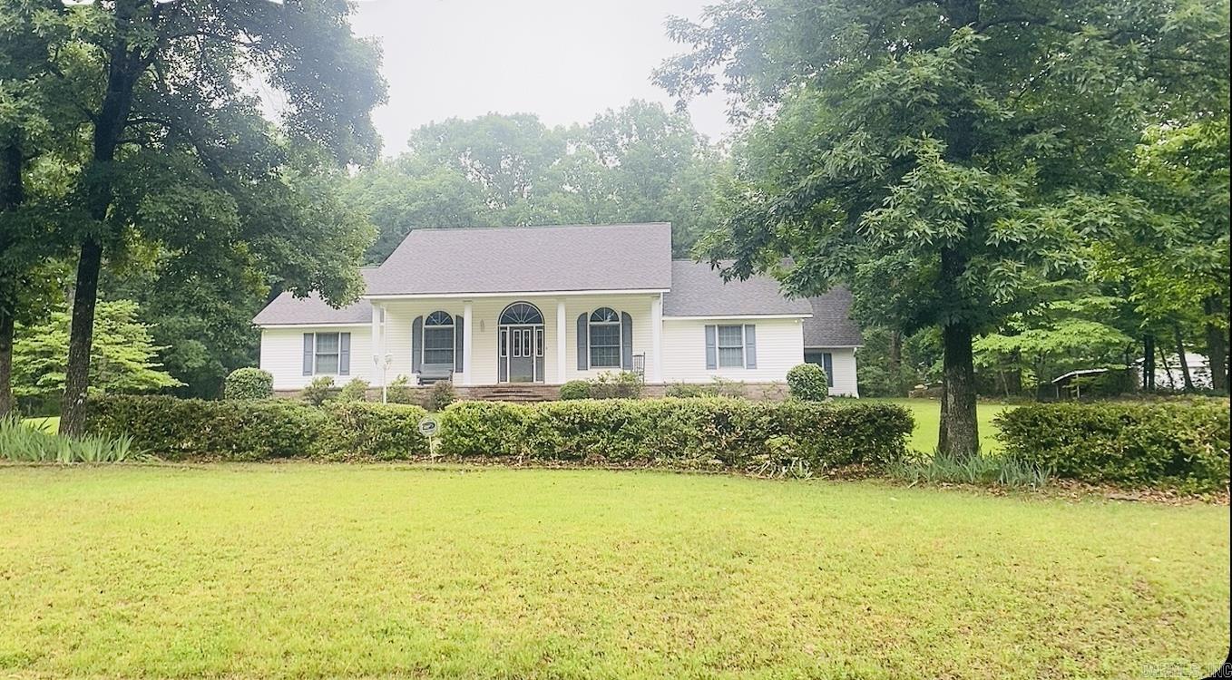 Set on 3 acres in the sought-after Mountain Aire community, this beautifully maintained 3,200 sq. ft. home blends Southern charm with thoughtful design. A circular drive, white columns, lush landscaping, and seasonal lake views create a warm welcome. Inside, 10-foot ceilings, new hardwood floors, and elegant archways lead to spacious living and dining areas. The kitchen features granite countertops, tile backsplash, island seating, abundant cabinetry, and a large walk-in pantry. A generous utility room includes built-ins for added convenience. The split floor plan offers spacious secondary bedrooms, while the private primary suite includes dual walk-in closets, double vanities, and ample storage. Upstairs, a large bonus room provides flexible space for recreation, work, or guests. Additional highlights include an oversized two-car garage with an underground storm shelter, partially fenced outdoor area, and a large shop with covered storage for boats, vehicles, or equipment. The property also features a fenced garden, fruit trees, blueberry bushes, and herb beds. Residents enjoy access to Mountain Aire’s lakes, fishing, trails, and kayaking! Truly, a piece of paradise!