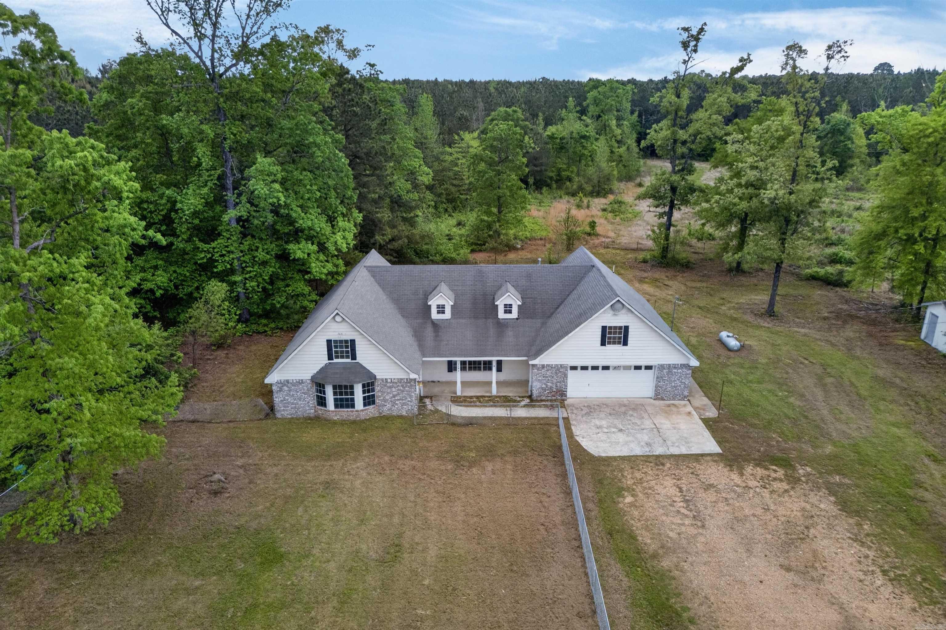 Welcome to 1480 Hwy 70 W, Dierks, AR. This property offers 7 acres of country living with a spacious home and multiple functional areas. The main level features an open-concept living, dining, and kitchen layout with abundant cabinetry, ample countertop space, and natural light throughout. Bedrooms are well-proportioned, and the home includes an upstairs den/bonus room suitable for a second living area, office, or recreational space.  Exterior features include a detached building ideal for storage, a workshop, or additional workspace. The acreage provides privacy and room for outdoor activities, gardening, or expansion. Located just minutes from Lake Greeson, this property offers convenience for outdoor and recreational enthusiasts.  Seller is offering $10,000 toward repairs with an acceptable offer.