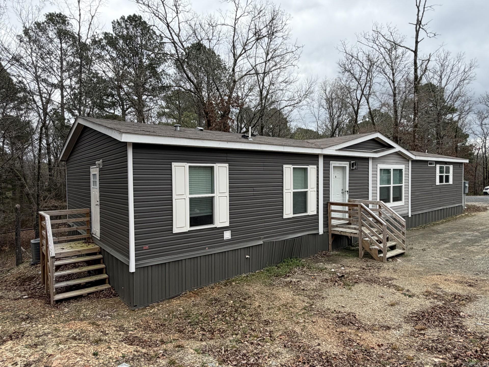 Check it out on the XOME auction. Located at the end of a cul-de-sac in the Hot Springs area, this 2023 manufactured home offers modern design and a functional layout. From the front entry, a mudroom station provides a convenient drop zone before opening into the living room, which flows seamlessly into the kitchen and dining areas. A breakfast bar island adds workspace and casual seating, and all appliances, including the washer and dryer, will remain. The primary suite is positioned just off the kitchen and features a spacious bathroom with a stand-up shower, soaking tub, and large walk-in closet. On the opposite side of the home, additional bedrooms are arranged near the laundry area, offering flexibility for a variety of uses. Conveniently located within reach of shopping, dining, and outdoor recreation opportunities in the Hot Springs region, this property combines newer construction with practical everyday living in a tucked-away setting. All offer terms are subject to third party approval as this will be a short sale. Please have preapproval or POF ready, if needed.