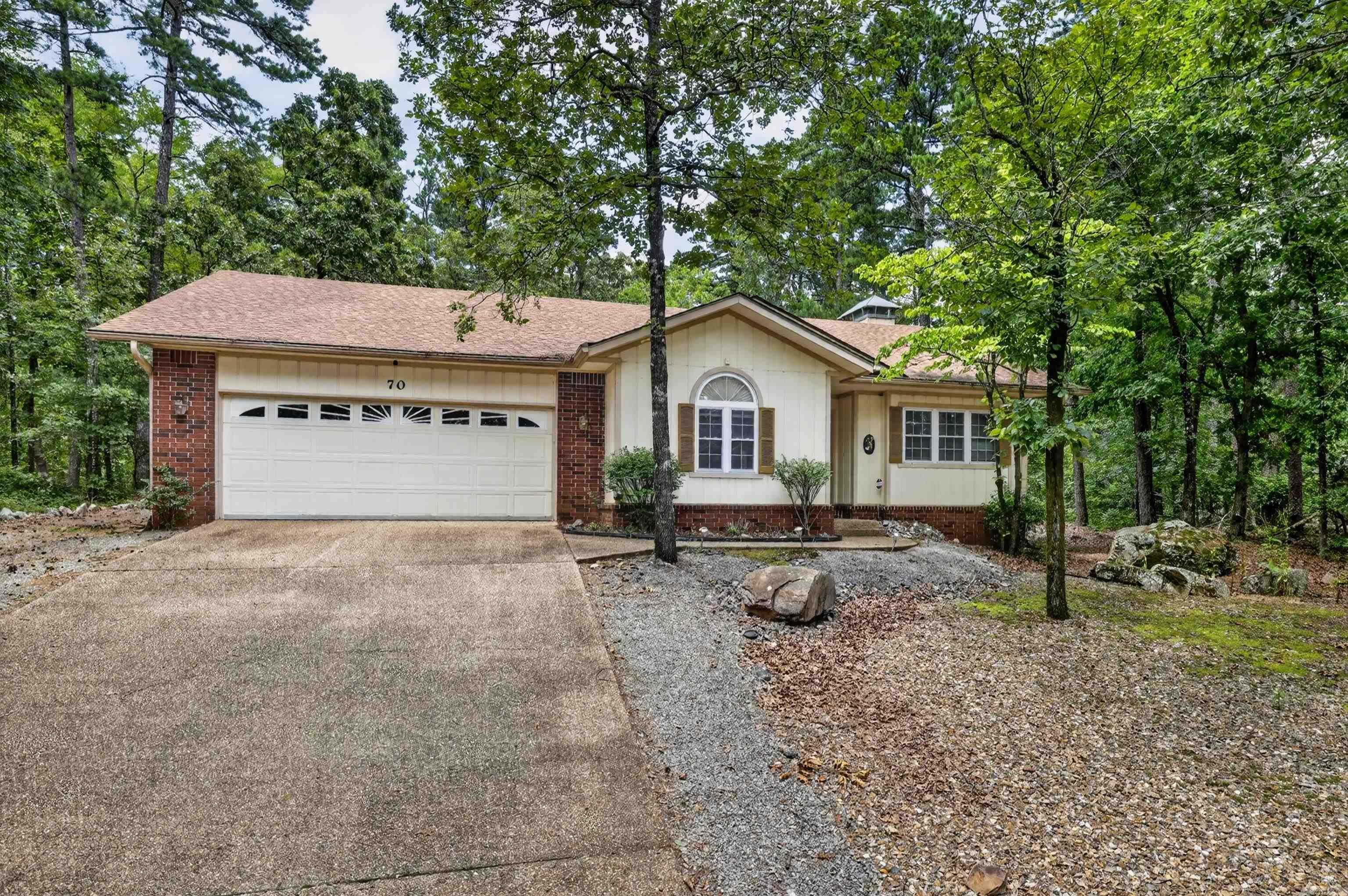 Private and spacious home surrounded by nature on all sides! Tucked among mature trees, this home offers a large fenced backyard and covered porch. ideal for enjoying the peaceful setting. Inside, the open living area features a cozy brick fireplace and flows easily into the dining and kitchen spaces. The split-bedroom floor plan provides privacy for the primary suite, which includes a spacious bath with double vanity, walk-in shower, and walk-in closet. Additional highlights include a large laundry room, deep garage with built-in storage, and flexible space for everyday living or entertaining. Conveniently located near the West Gate with easy access to shopping, dining, medical facilities, and more. HVAC 8/2025