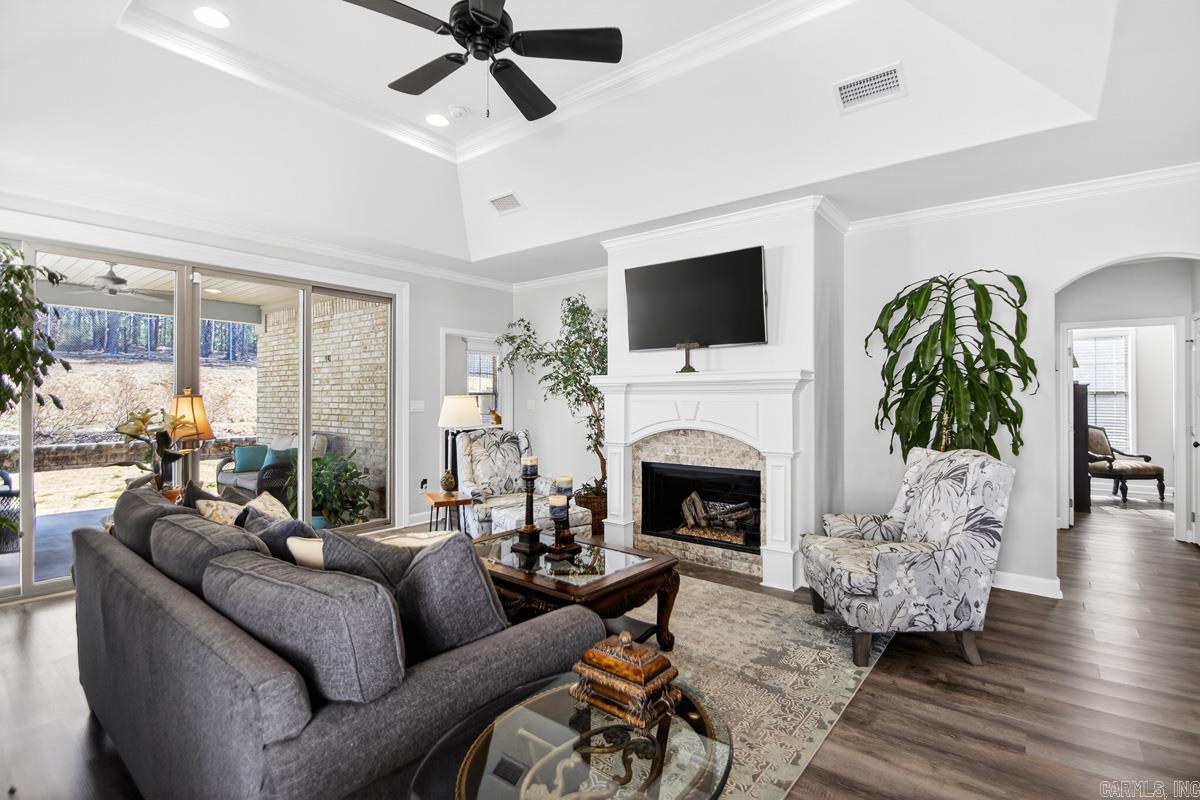 Refined, custom-crafted living in Parkside.** This beautifully designed one-story home pairs architectural tray ceilings with a dramatic 12-foot quad sliding door that fills the living space with natural light and creates seamless indoor-outdoor flow to the patio and greenbelt backdrop. The kitchen is thoughtfully appointed with granite slab countertops, tile backsplash extending above the oven, pantry, lazy Susan, and integrated spice storage. The primary suite offers a true retreat experience with heated tile floors, freestanding soaking tub, solid stone counters, vanity seating, and walk-in shower. The guest bath features a tiled tub surround for a polished finish. Additional enhancements include floor outlets in the living area, gutter screens, sprinkler system, and tankless water heater. HOA-provided lawn care — mowing, leaf collection, shrub trimming, weed eating, and walkway clearing — allows for effortless, low-maintenance living. Ideally located near Chenal amenities, Bowman Curve and Costco.