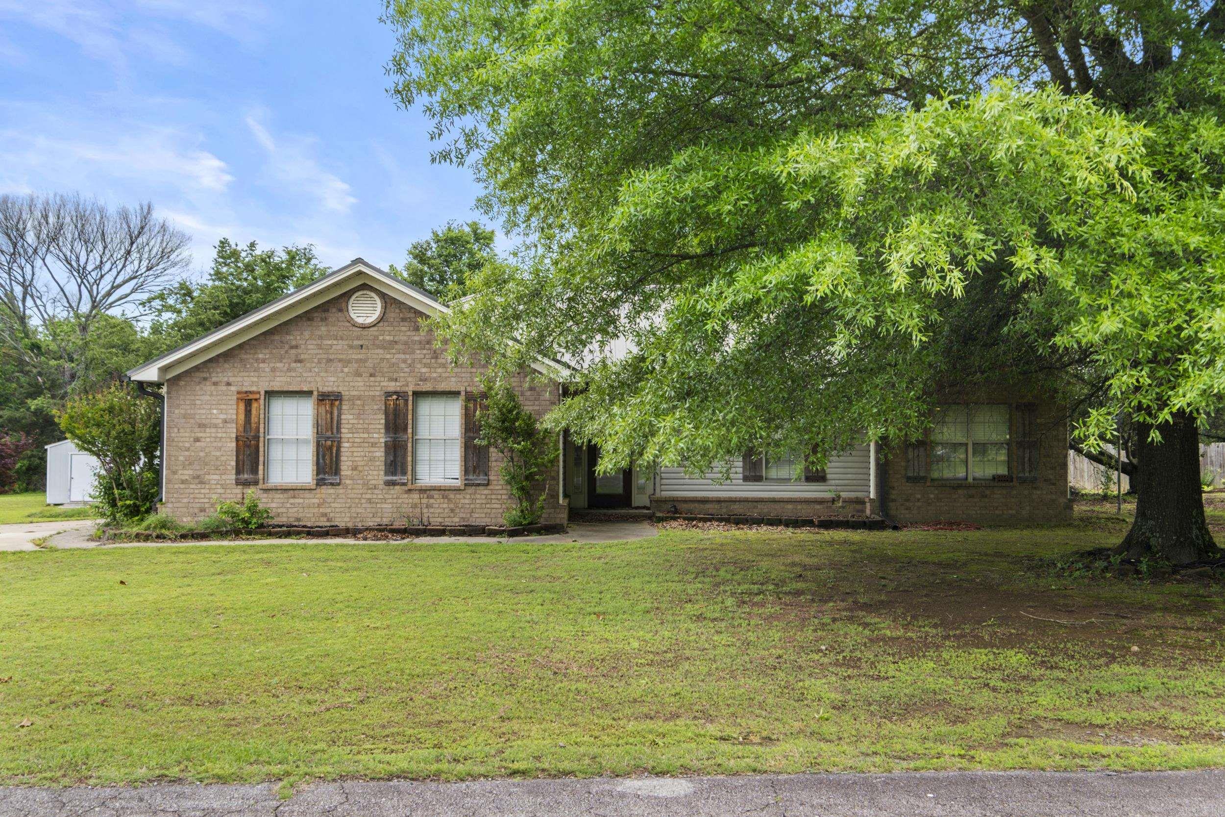 Space for you, space for the kiddos, space for your dogs or a horse!!!!  This 4 bdrm 3 full bath house sits on an acre just outside Searcy and seller tells me this is a wonderful neighborhood.  House is all electric, the garage has been transformed into a 4th bdrm that was used  as an "in-laws" suite with a walk in shower in the bathroom. . New commercial grade tile floors when the house was remodeled in 2018, kitchen updated with a farm sink and subway tile and quartz countertops and stainless appliances. This home is spacious and inviting.  There is a cozy office space with a reading nook/sunroom on the back of the house which opens to a large deck and backyard that includes flower/garden beds, apple trees and a premier basketball court.  There are two BEB storage buildings,   so, there is lots of storage inside and out!  Lots of possibilities with this property!  Call for your showing!