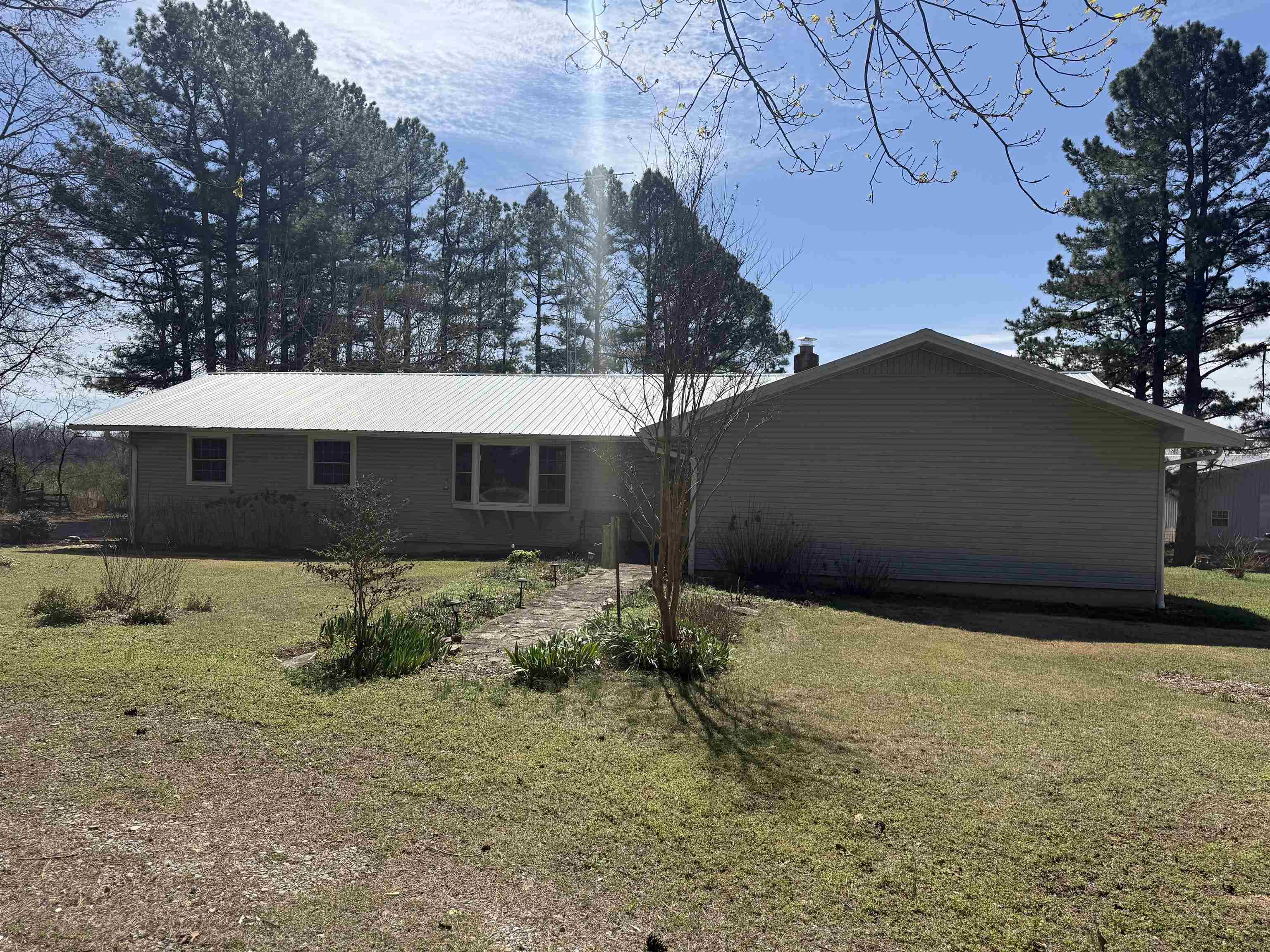 PRICE IMPROVEMENT!  Located at the end of a winding drive in the heart of Ash Flat, this beautiful 41-acre property offers rolling pasture, scattered trees, and a peaceful pond and beautiful quiet setting. The quality-built home was designed with comfort and versatility in mind, ideal for multi-family or in-law living. The upper level features 3 bedrooms and 2 baths with hardwood flooring, crown molding, and marble countertops in the kitchen and baths. The lower level includes 2 bedrooms, an office/den, a full kitchen, large pantry/canning closet, and a spacious sunroom. Designed with handicap accessibility, the lower level also has its own private entrance. An electrostatic air purifier provides cleaner indoor air. Outside, a 40x60 insulated shop offers partial concrete floors, multiple overhead doors, and its own water heater, toilet, shower, and septic system. Situated along a quiet city street, yet conveniently close to banks, medical services, Walmart, and the post office. Updates completed over the years (list available upon request).