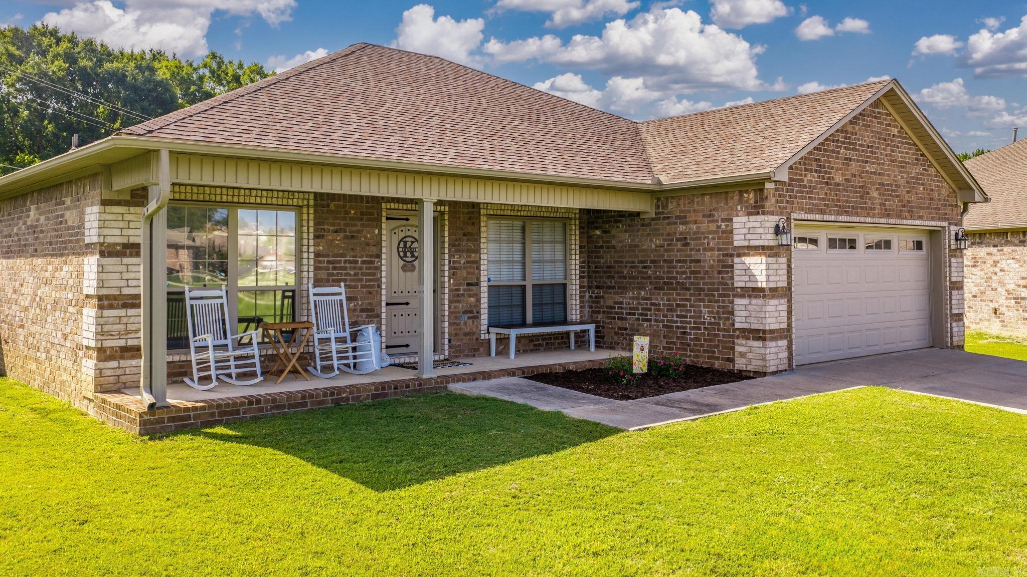 Beautiful 3-bedroom, 2-bath home in the Churchill Downs subdivision in Austin,  conveniently located just 20 minutes from Little Rock Air Force Base. Situated on the largest lot in the neighborhood, this property offers exceptional outdoor space with a fully fenced backyard, a covered back porch, and a welcoming front porch that's perfect for rocking chairs.  Inside, the open-concept floor plan seamlessly connects the kitchen, dining, and living areas, creating an ideal space for everyday living and entertaining. Soaring ceilings enhance the home's spacious feel, while the split-bedroom floor plan provides privacy for the primary suite. The primary bathroom features a large, tiled walk-in shower.  With its oversized lot, functional layout, inviting outdoor living areas, and convenient location, this home offers the perfect blend of style, space, and everyday practicality.