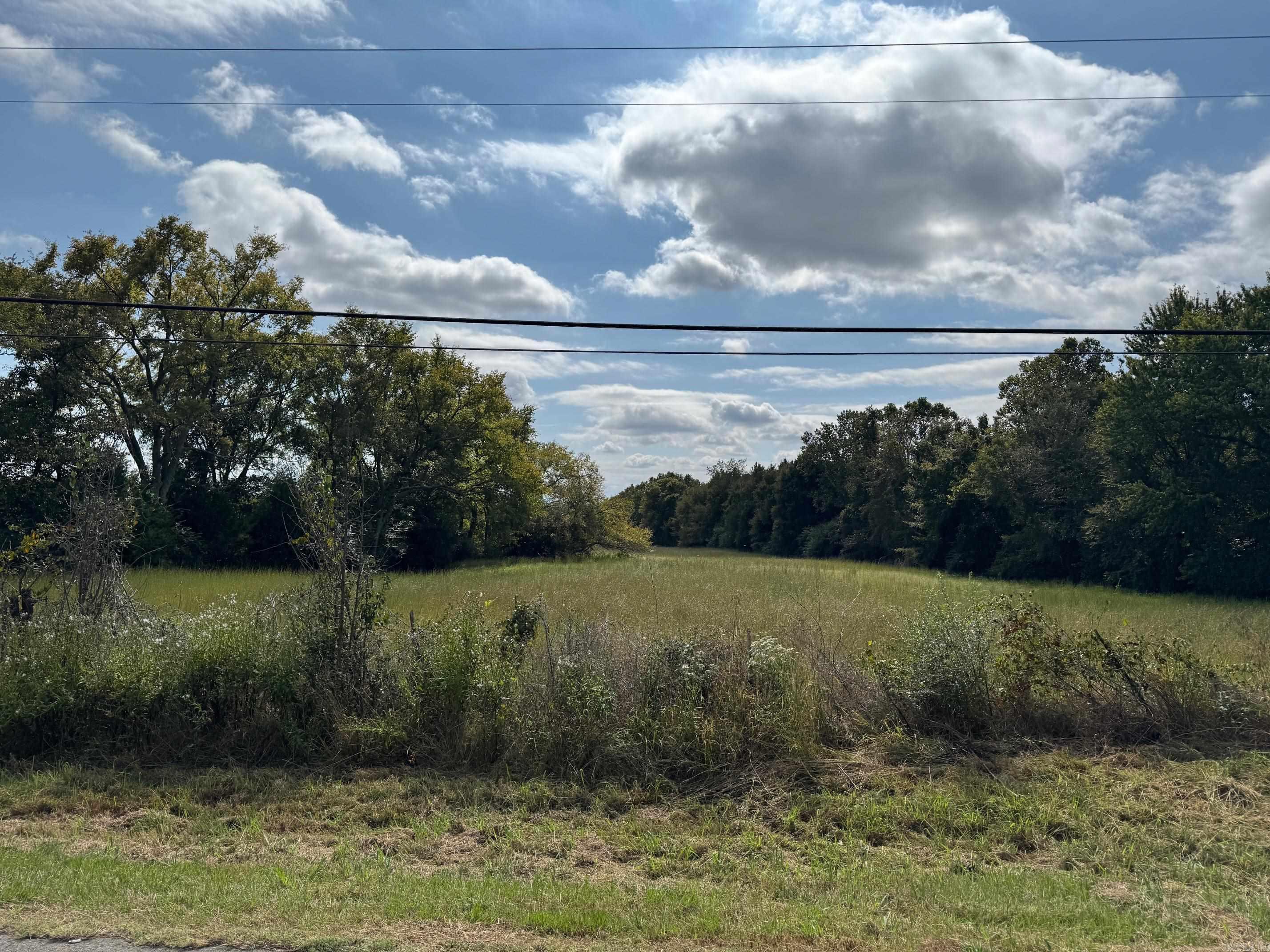 WESTERNMOST ONE ACRE TRACT OF THREE FOR SALE. OVER 200 FT OF HWY #64 FRONTAGE ACROSS THE STREET FROM WHERE A NEW METAL BUILDING SALES & CONSTRUCTION LOCATION IS SUPPOSED TO BE RE-LOCATED FROM ELSEWHERE IN THE COUNTY. DIAGONAL TO THE SOUTHWEST FROM THE COAL HILL DOLLAR GENERAL& GAS STATION. CLOSE TO WESTSIDE SCHOOLS. NEXT TO RESIDENTIAL HOME THAT IS JUST TO THE WEST. SEWER & WATER MAINS ON THE LOT! SOME TREES ON THIS LOT ON WESTERN EDGE. LAYS PRETTY WELL. MOSTLY OPEN LAND. GREAT CUSTOM HOME OR DUPLEX LOCATION.