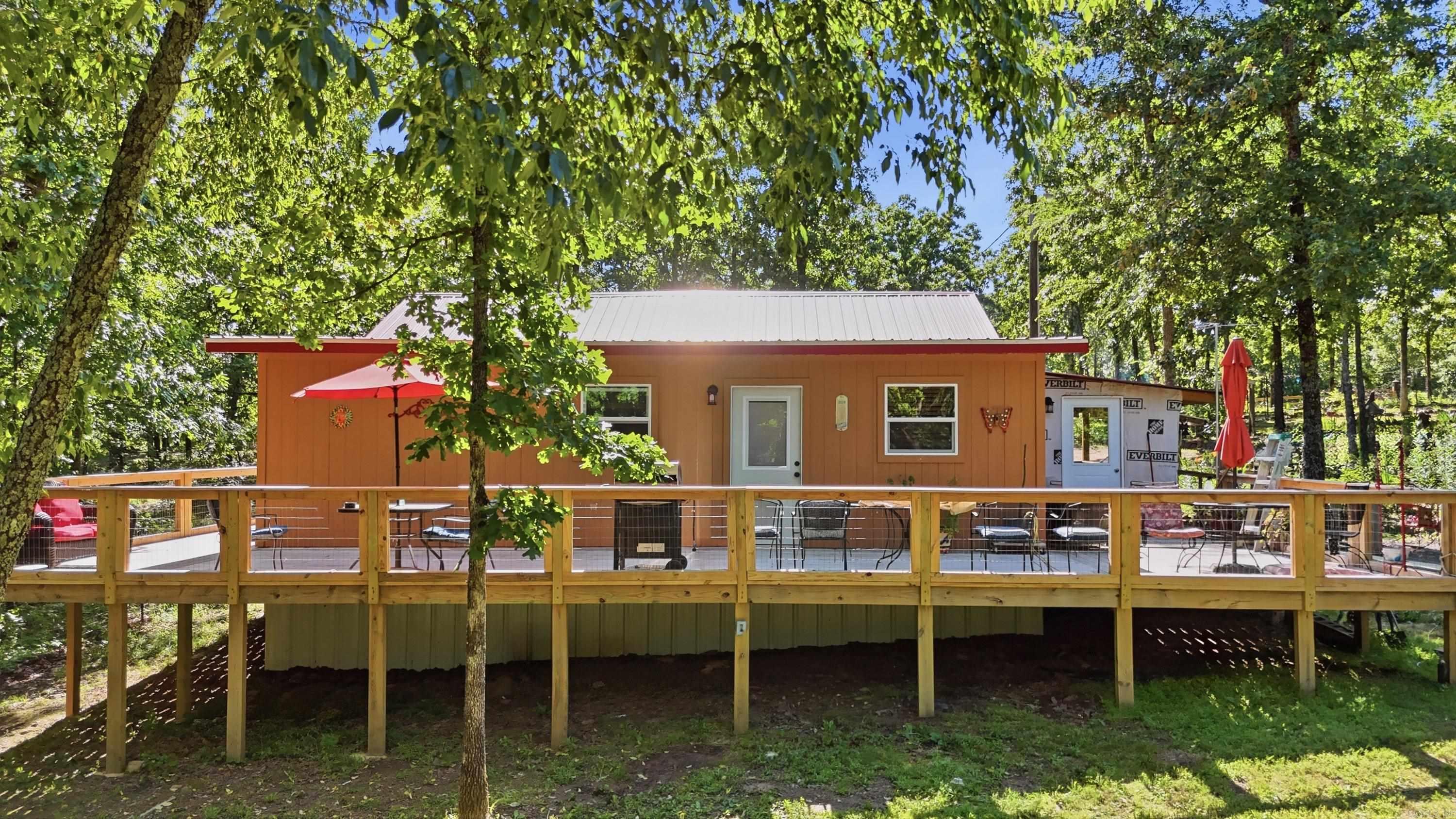 Tucked away on 6 private acres in Jacksonville, this charming 2 bed, 2 bath cabin offers peaceful country living with endless possibilities. Situated on a private road, the property features a welcoming wraparound porch perfect for enjoying quiet mornings and beautiful Arkansas sunsets. The home is wheelchair accessible and thoughtfully laid out for comfort and convenience. A circle driveway provides easy access and plenty of parking, while the beautifully maintained landscaping showcases an abundance of flowers lovingly planted by the seller. Whether you’re looking for a private residence, weekend retreat, investment opportunity, or space to expand, this unique property is full of potential and ready for its next chapter.