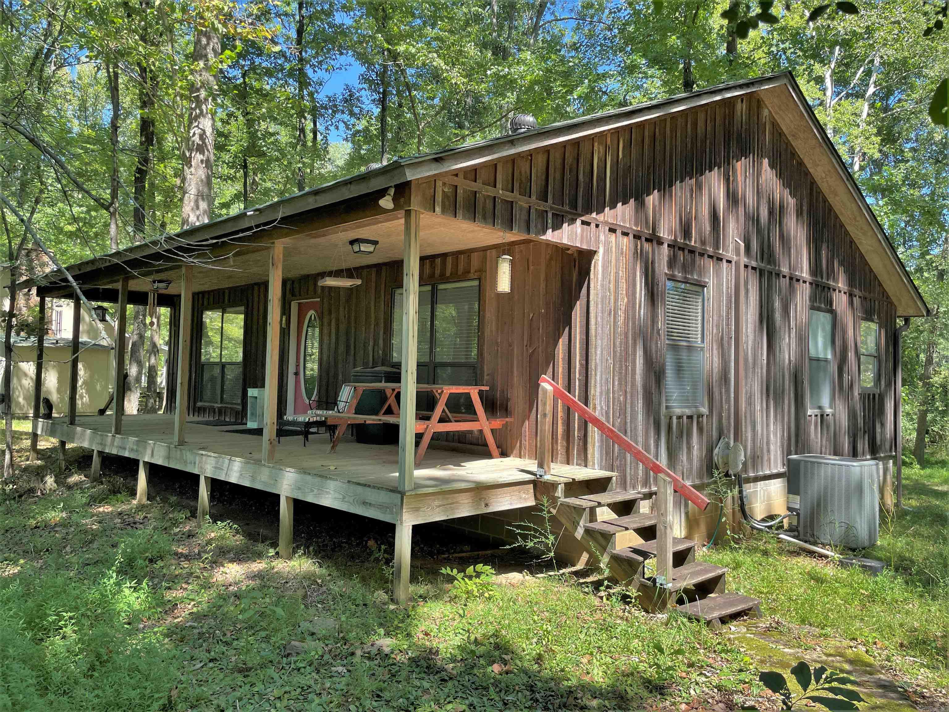 Check out this cozy rustic cabin with boat dock, situated on a wooded lot on the Little Red River.  2 bedrooms, 1 full bath, plus a additional shower in the laundry room. Open kitchen / living room. Large back porch to enjoy after a day of trout fishing.  Unfinished basement/utility room.