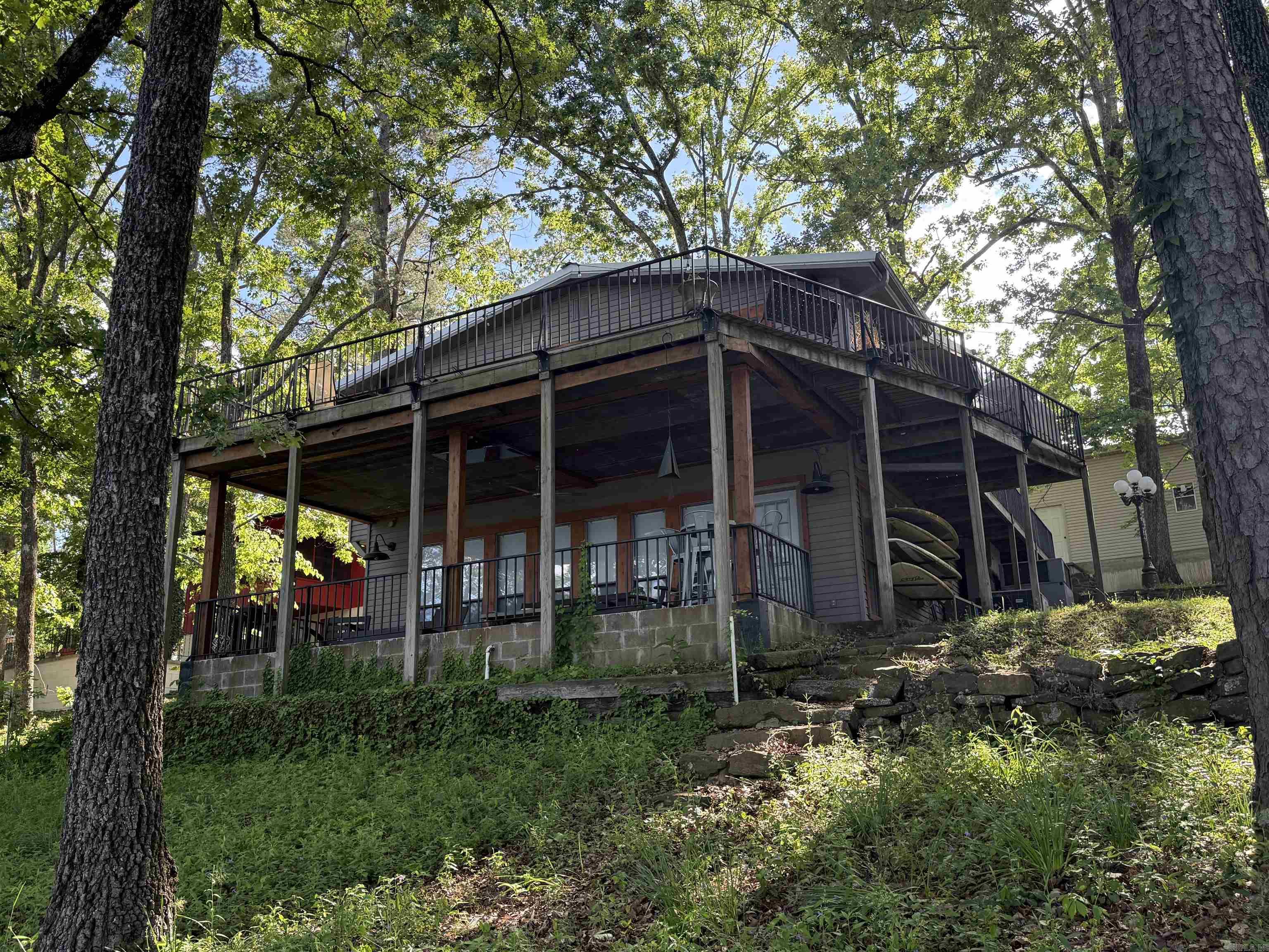 LAKEFRONT. AWESOME VIEW. EASY WALK TO THE WATER. GORGEOUS SHORELINE. What more can you ask for?! This HOME is perfect for weekend lake life with friends and family or full time LIVING. Don't let the age of the home fool you. The owner has made many updates throughout, including external HVAC system less than 10 years old.  The large upper deck is perfect for entertaining and enjoying the beautiful view of the lake and the lower patio is just the area needed for enjoying your morning coffee. The large 70x21 ft shop has plenty of room for storing all your lake toys. Pictures do not do this place justice.