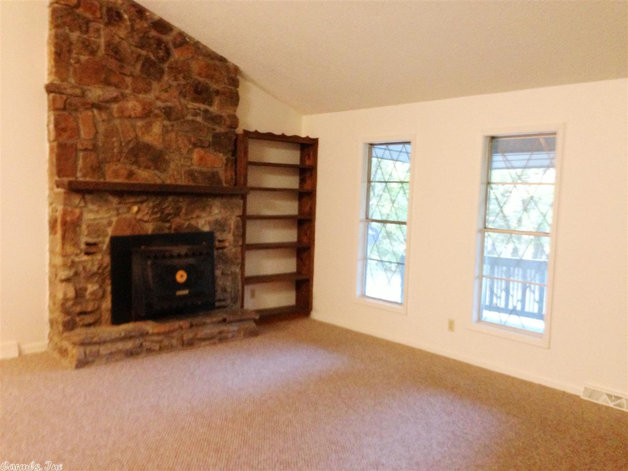 PRICE REDUCED! Great open floor plan home featuring vaulted ceiling, native stone fireplace and insert, 2013 air conditioner with 10 yr warranty! 2 roomy bedrooms (master is 16 x 13!), newer vinyl flooring & Berber carpet, 12 x 9 back deck (new 2011), 17 x 8 covered front porch, plus carport! Home has private feel, as it is wooded on 3 sides with no immediate neighbors! Listing #1931