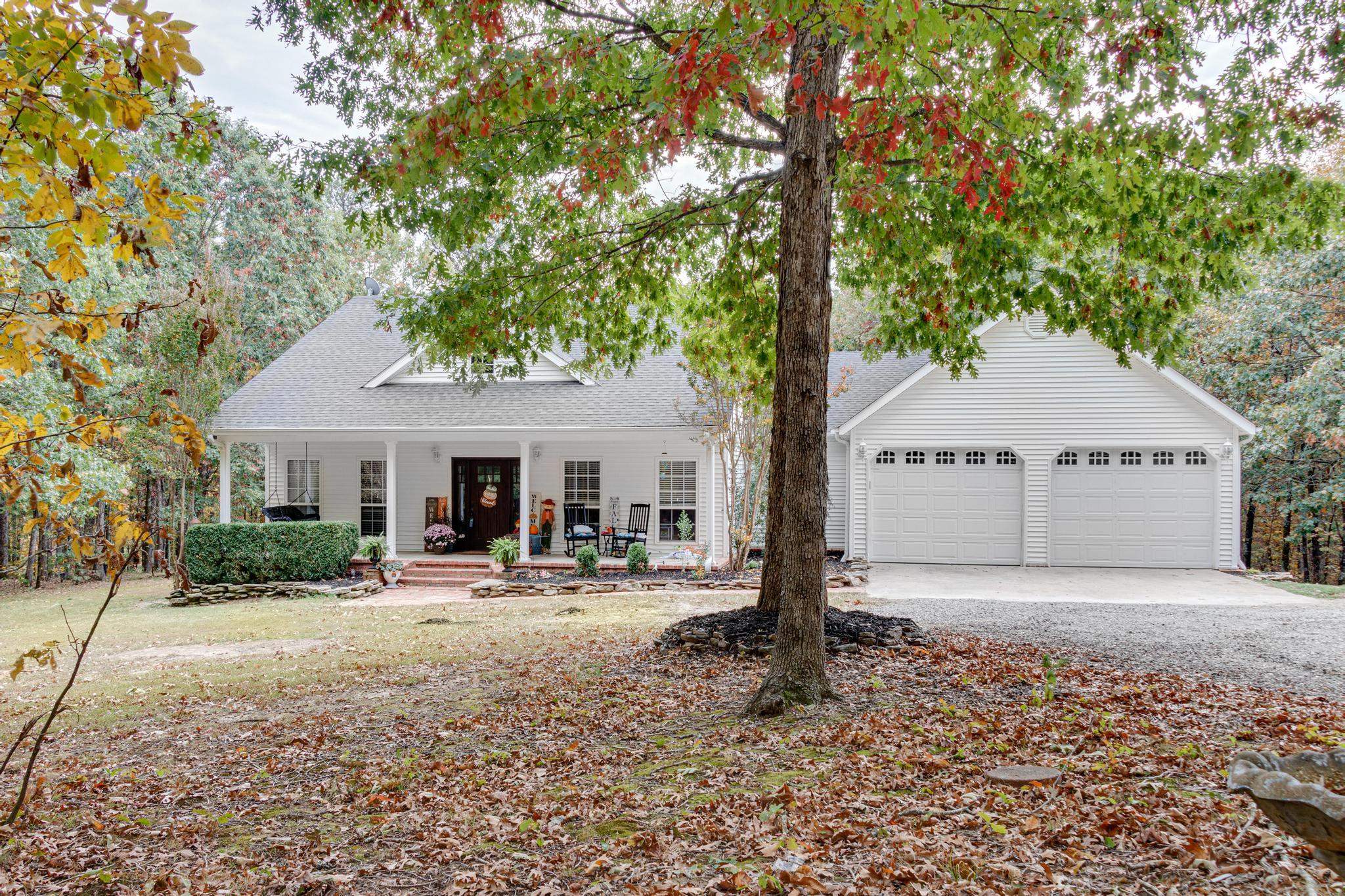 Enjoy tranquility with over 11 acres, two ponds (one with a dock), and a heated and cooled 30x50 shop featuring a kitchenette with hot & cold water, a safe room, 1/2 bath, two 8x10 bay doors, and a dog run area. In the back of the shop, there is an additional room to park your lawn mower.  The home offers three bedrooms in a split-bedroom layout, a great room, and a versatile formal dining area. The granite island kitchen has plenty of seating, and the laundry room offers extra storage.  Stained concrete floors, carpeted bedrooms, and both front and back outdoor living spaces add to the charm. Roof (2021) and HVAC (2019)