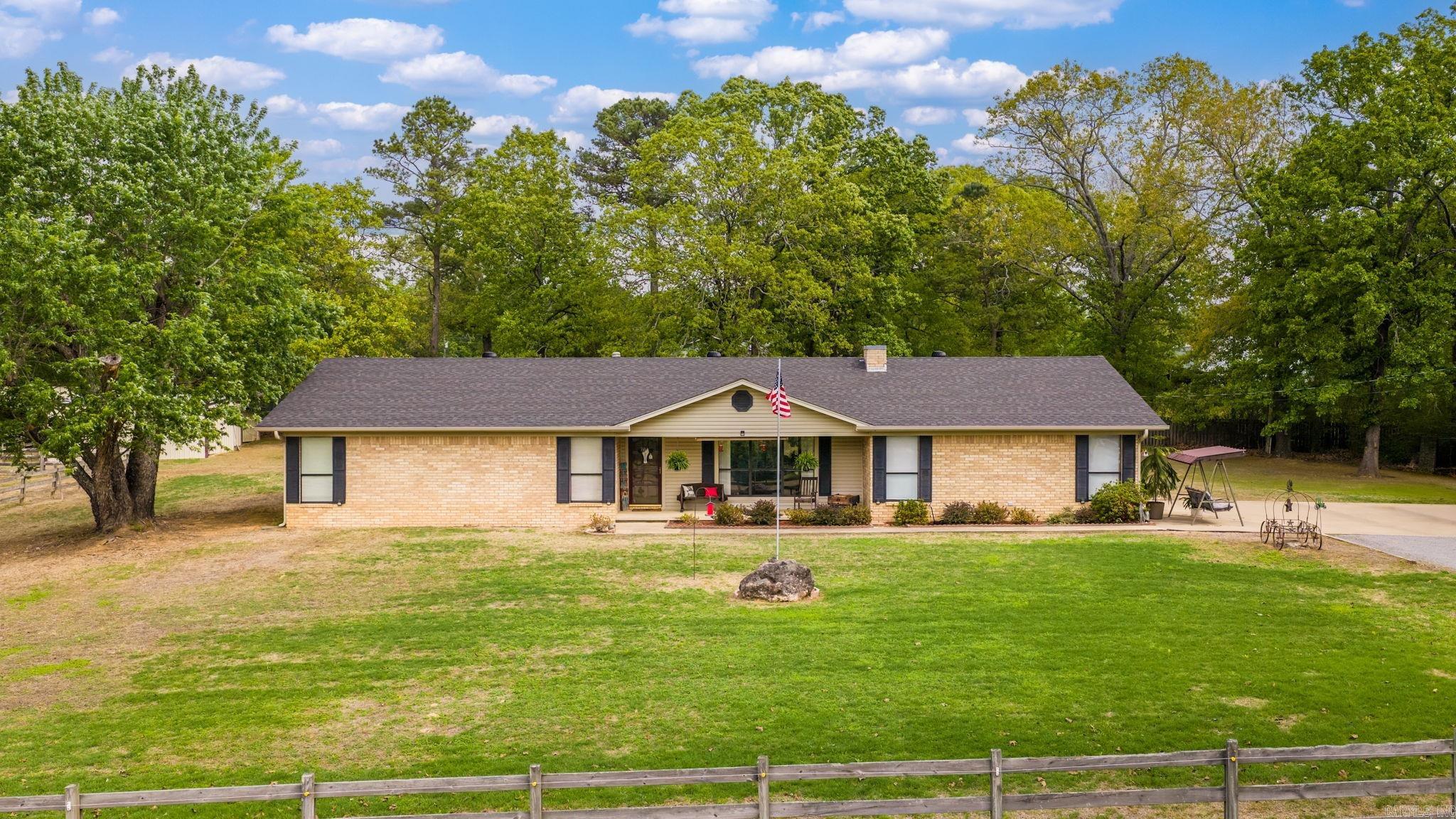 Enjoy peaceful country living on approximately 3 acres with this well-maintained home offering comfort, space, and functionality. Inside, you’ll find beautiful hardwood floors, a spacious living area, and an electric fireplace that can easily be converted to wood-burning for added charm. The kitchen features ample cabinetry and workspace, while the oversized laundry/mudroom provides excellent storage and everyday convenience.  Recent updates include a roof that is just 2 years old and an HVAC system only 1.5 years old, along with gutters equipped with protective covers for easy maintenance. Additional attic storage ensures plenty of room for seasonal items and extras.  Outside, the property truly shines with wide-open space and endless possibilities. A barn and a small shop with an insulated ceiling, plus power and water access, makes an ideal setup for hobbies, projects, or storage. Relax on the inviting front porch and enjoy the privacy, mature trees, and peaceful surroundings. All furnishings are negotiable, making this a move-in ready opportunity.  Don’t miss your chance to own this versatile and well-cared-for property with room to live, work, and unwind. No Restrictions!
