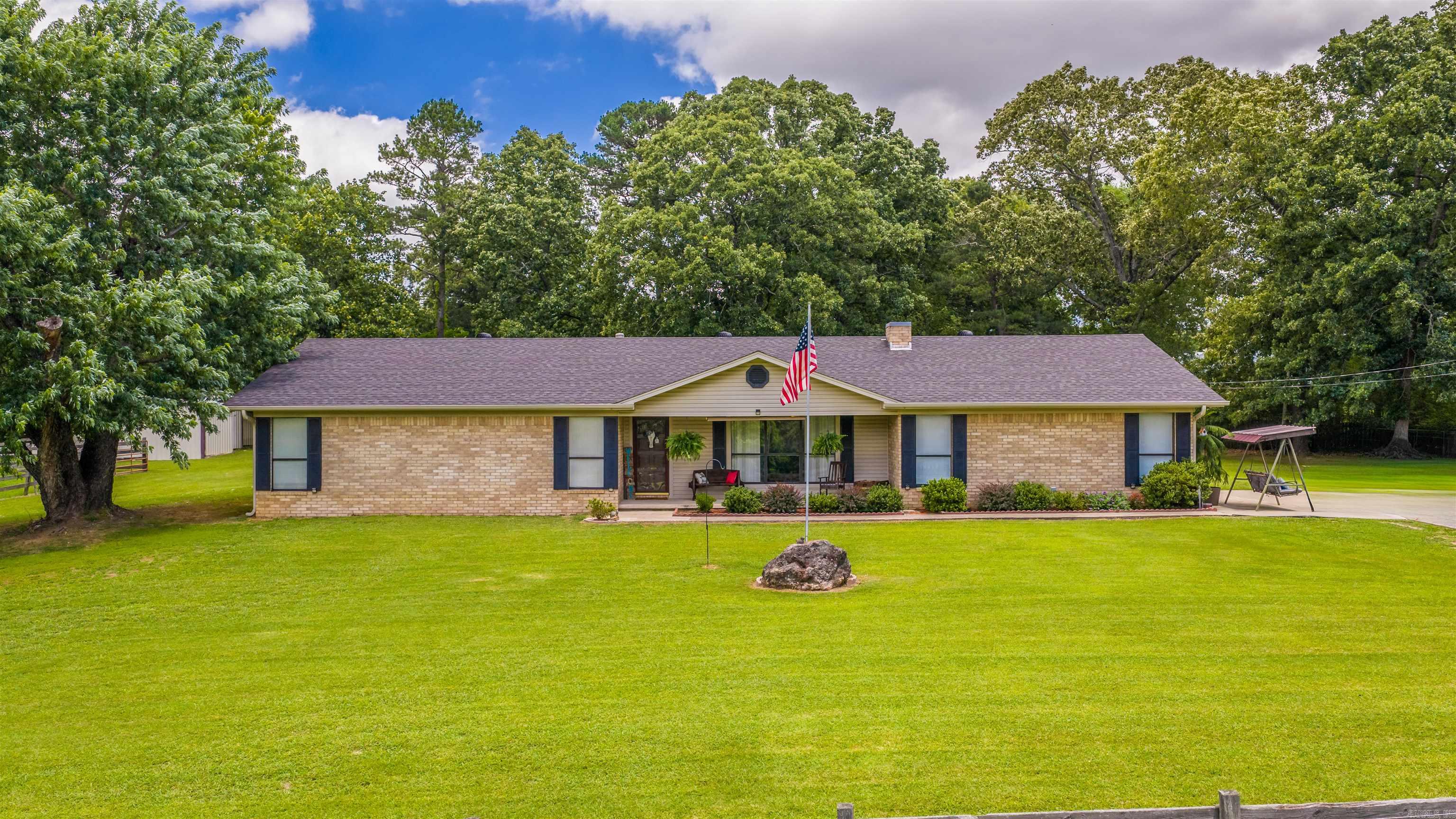 Enjoy peaceful country living on approximately 3 acres with this well-maintained home offering comfort, space, and functionality. Inside, you’ll find beautiful hardwood floors, a spacious living area, and an electric fireplace that can easily be converted to wood-burning for added charm. The kitchen features ample cabinetry and workspace, while the oversized laundry/mudroom provides excellent storage and everyday convenience.  Recent updates include a roof that is just 2 years old and an HVAC system only 1.5 years old, along with gutters equipped with protective covers for easy maintenance. Additional attic storage ensures plenty of room for seasonal items and extras.  Outside, the property truly shines with wide-open space and endless possibilities. A barn and a small shop with an insulated ceiling, plus power and water access, makes an ideal setup for hobbies, projects, or storage. Relax on the inviting front porch and enjoy the privacy, mature trees, and peaceful surroundings. All furnishings are negotiable, making this a move-in ready opportunity.  Don’t miss your chance to own this versatile and well-cared-for property with room to live, work, and unwind. No Restrictions!