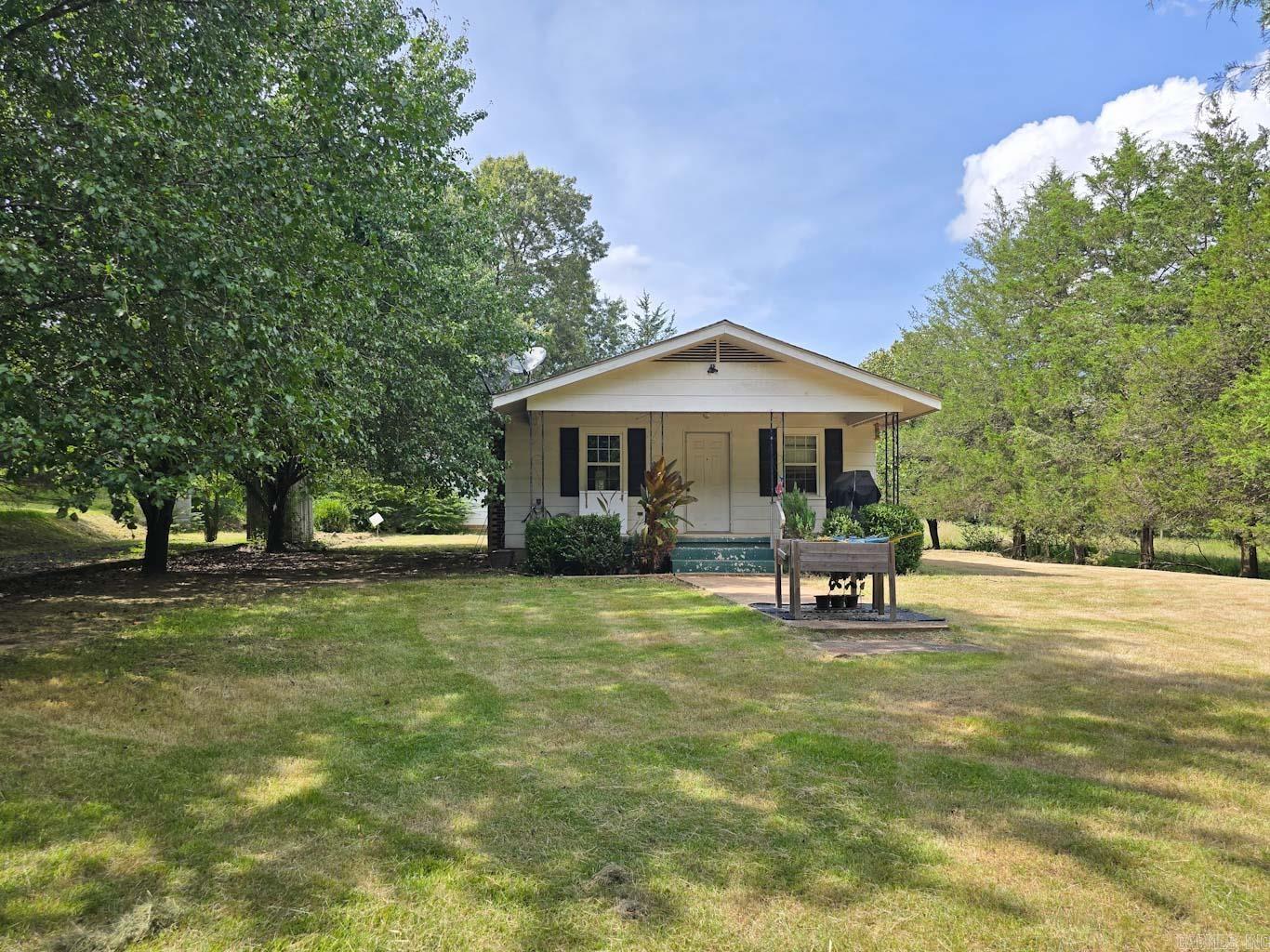 Escape to rural tranquility with this 16.15-acre property in Hatfield, Arkansas! This 3-bedroom, 2-bathroom home offers an open floor plan, ready for your personal touches. While the home needs some work, it presents an incredible opportunity to create your dream country retreat. The property is a haven for hobby farmers or those seeking space, featuring a detached garage, a barn, and it has fencing already in place for livestock. A gated driveway ensures privacy and security. Embrace the potential and make this expansive property your own slice of Arkansas paradise.