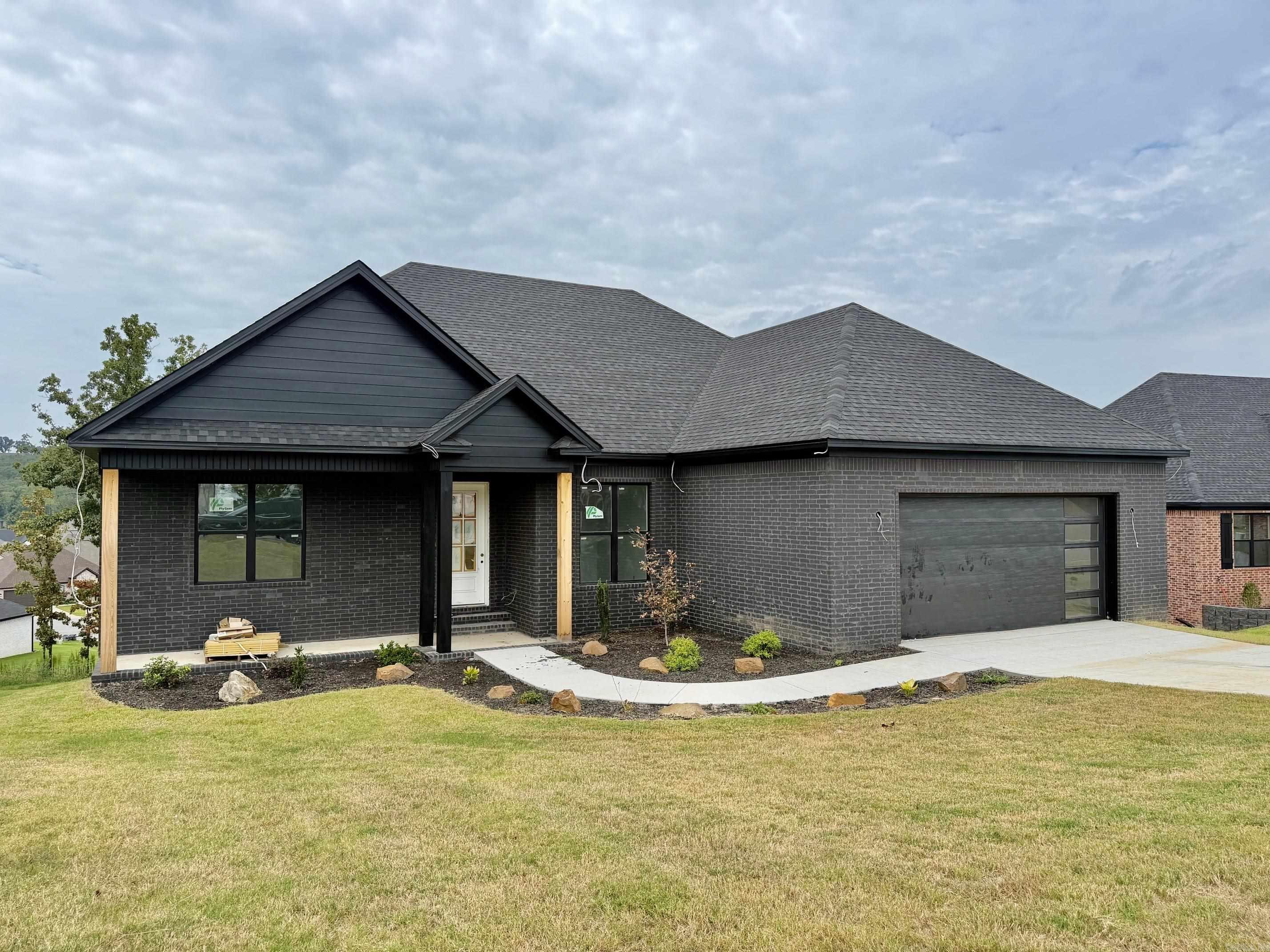 Welcome to this beautiful new construction home offering the perfect blend of modern design and everyday comfort! This thoughtfully designed home features 3 bedrooms, 2 full bathrooms, plus a dedicated office-ideal for working from home or creating a flexible living space. The open-concept living and dining area is perfect for entertaining and is highlighted by a cozy gas fireplace with custom floating shelves on each side, creating a warm and inviting focal point. The spacious kitchen is designed with both style and function in mind, featuring a large center island, abundant cabinetry, and plenty of workspace for cooking and gathering. The oversized primary suite offers a relaxing retreat with a luxurious ensuite bath complete with dual vanities, a walk-in shower, and a soaking tub. Step outside and unwind on one of the dual covered back porches, providing the perfect space for morning coffee or evening relaxation. Estimated completion is mid-September, giving buyers a limited opportunity to personalize finishes and make this home truly their own. Don't miss your chance to own a brand-new home tailored to your style!
