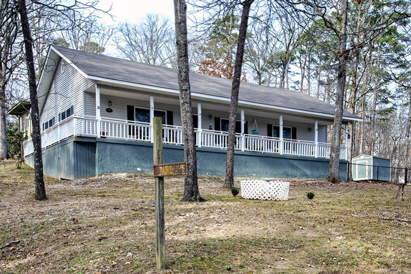 This spacious 2,052  square foot one-level lakeview home offers a peaceful retreat as well as a perfect venue for entertaining. Recently updated with timeless hardwood flooring, granite countertops, new HVAC system, and stainless steel appliances. The exquisite living/dining room with a cozy fireplace, the gourmet kitchen, and the large den/bonus room will enhance every moment of owning such a unique and tranquil retreat. Step outside just beyond the den onto a large patio with a vast fenced yard! Even your fur baby/babies will be happy! Enjoy a picturesque lake view from your expansive covered front porch—the perfect spot to relax at sunrise, midday, or sunset. ALL FURNISHINGS ARE NEGOTIABLE!! So just unpack your bags and enjoy your beautiful home!