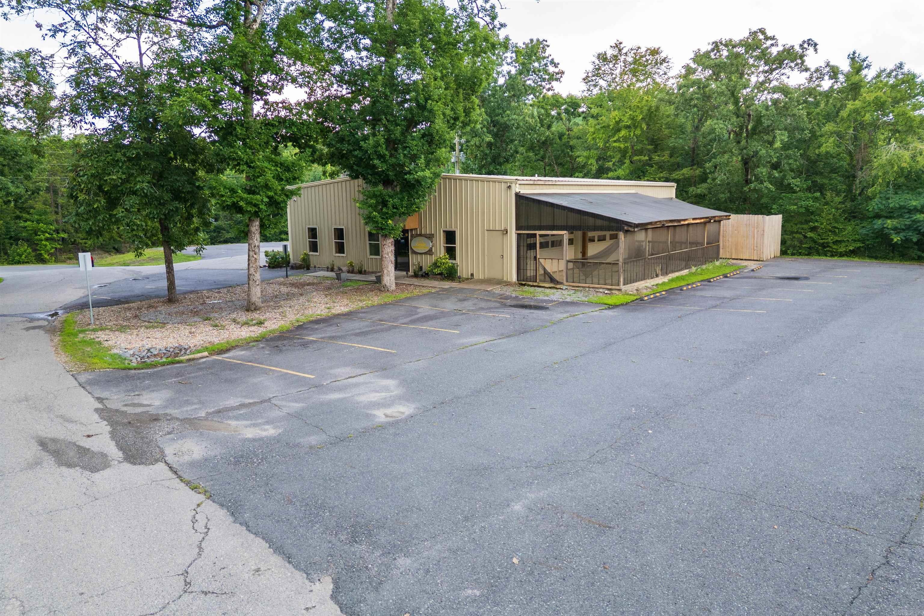 This commercial opportunity in Hot Springs Village is a rare find. This 2,900 sq. ft. commercial metal building comes fully equipped with complete HVAC and electrical systems, situated on a 0.5-acre lot with paved parking. With estimated development costs ranging between $230,000 and $355,000, this property is a blank canvas ready for your vision. Don't miss the opportunity to make it your reality! Whether you are looking to establish a hobby garage, a restaurant, a private card club, or a car museum, the possibilities for this space are endless.