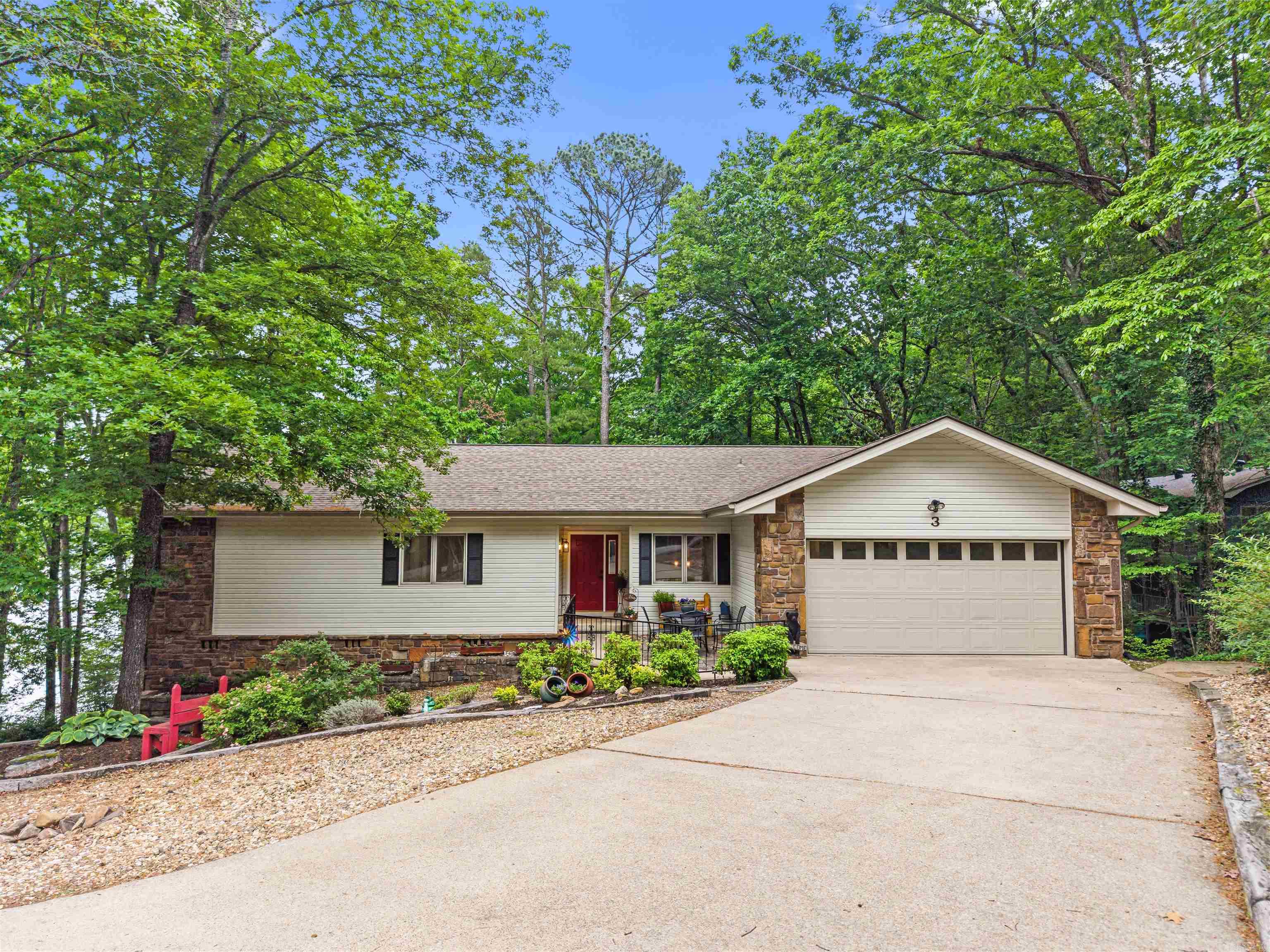 Nicely remodeled home with lake view and common area access to Lake DeSoto! Launch your kayaks right from the shore! Wood burning fireplace in the huge great room with slider to entertainment size rear deck with view! Quality luxury vinyl plank flooring on both levels! Primary bedroom also has access to the deck, a dual vanity, shower and walk-in closet! The Arkansas room offers yet a 3rd access to the deck and a wall of windows overlooking trees and Lake DeSoto! The basement features a fully remodeled full bath, the 3rd bedroom, and a slider to the rear patio! Workshop on side of home is large enough for a workbench and additional storage. Large Laundry room and 1/2 bath! Walk to the nearby Waypoint Marina or continue on a several mile long walking trail! The 26,000 gated acres of Hot Springs Village boasts 11 lakes & 9 golf courses, fitness center, tennis, pickleball, 2 pools, 20+ miles of walking trails, mini golf, bocce ball, and much more! DON'T MISS THE VIRTUAL TOUR!