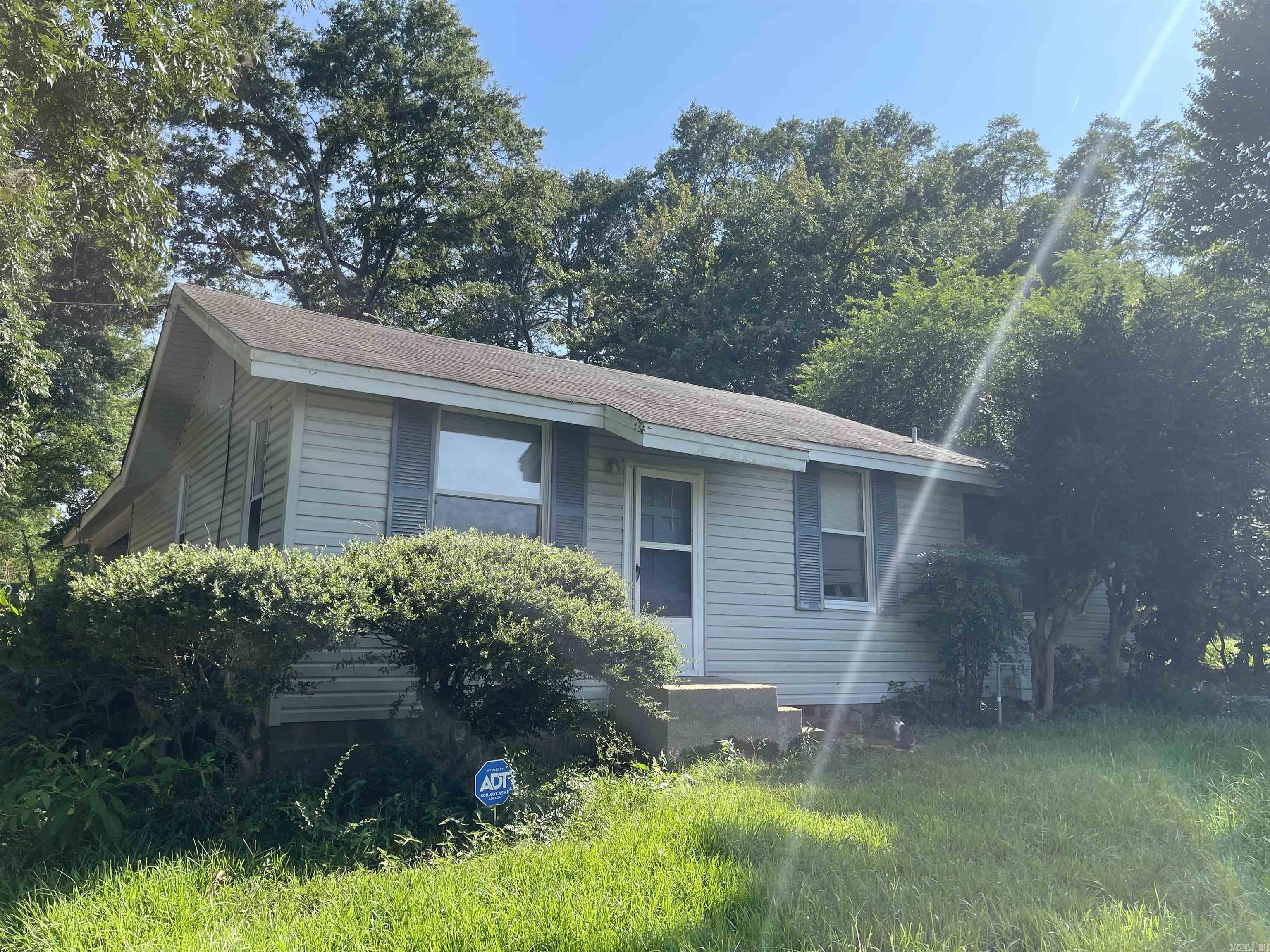 This location is great for commercial or residential use.  Close to town on the bustling West side.  Property has a 2 bedroom/ 1 bath house with carport.  Narrow at the front but widens out at the back half of the property.  Property to be sold AS IS.