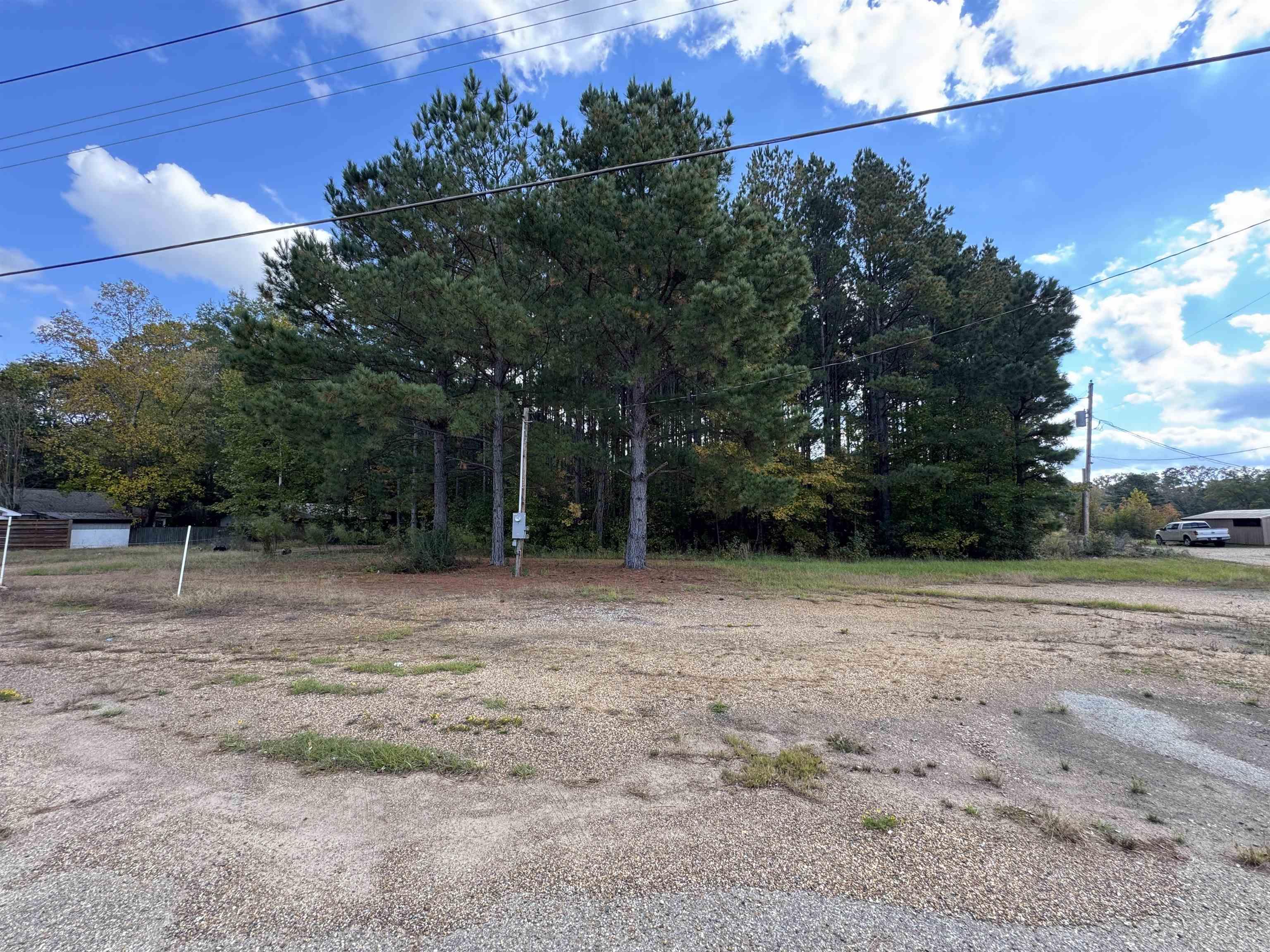 Conveniently located in a high traffic area, this 4+ acre parcel provides dual use. Whether you are seeking commercial visibility, or a spot to build a home tucked off the main road, this unique parcel offers both. All utilities are accessible at the street and includes a recorded easement to access the back of the property.