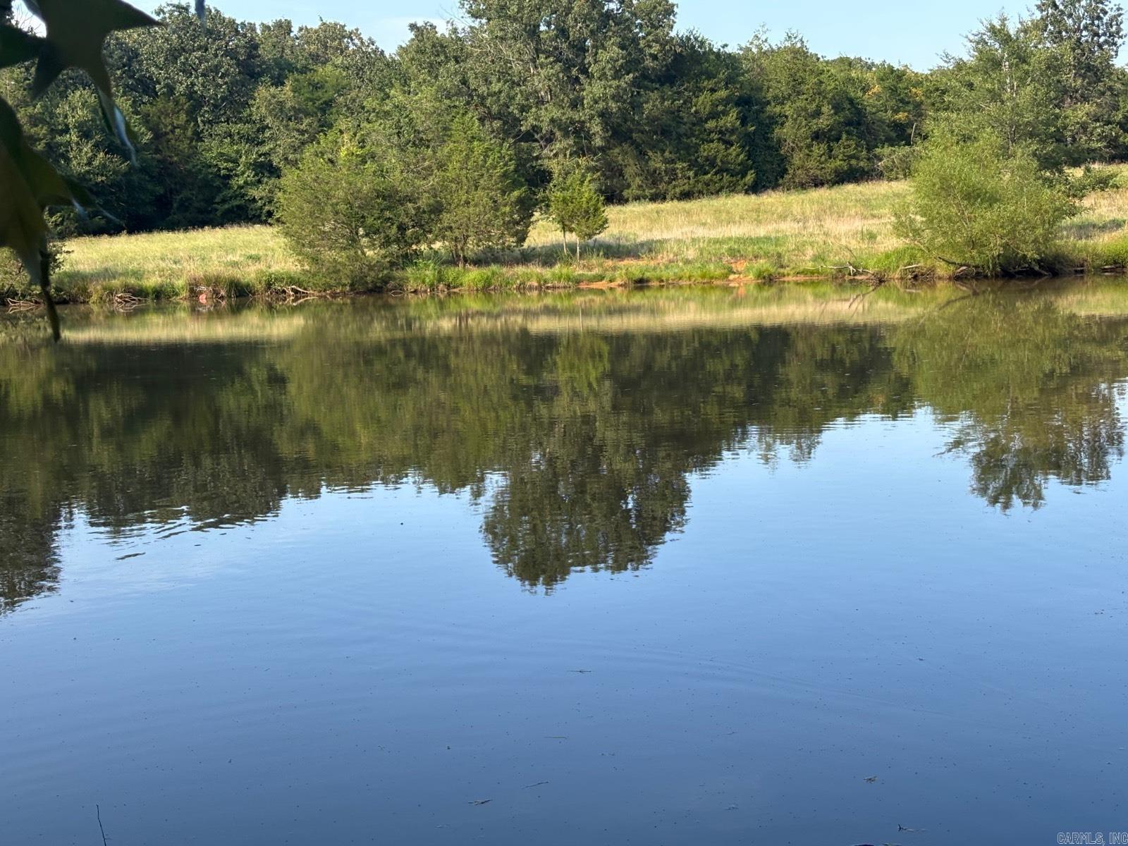 30 acres of country paradise! **Prime Rural Property with Exceptional Potential** Escape to the country with this versatile 30-acre property offering endless possibilities for farming, homesteading, or recreation. Located in peaceful rural setting with convenient access. ## Key Features: - **30 acres** of prime country land - **FULLY FENCED** - **1-acre stocked pond** - perfect for fishing and wildlife - **Quality pasture land** ideal for livestock or hay production - **Complete perimeter fencing** - ready for livestock operations - **Pole barn** for equipment storage and workshops ## Buildings & Infrastructure: - **3 chicken houses** - one in excellent condition for poultry operation or equipment storage, second structure with potential for renovation - **Dual water sources**: 2 private wells PLUS city water hookup for ultimate reliability - **4 separate electrical meters** providing flexibility for multiple uses for building your home or rental income potential ## Perfect For: - Hobby farming or commercial agriculture - Livestock operations (cattle, horses, goats) - Equipment storage and workshop space - Private retreat or homestead
