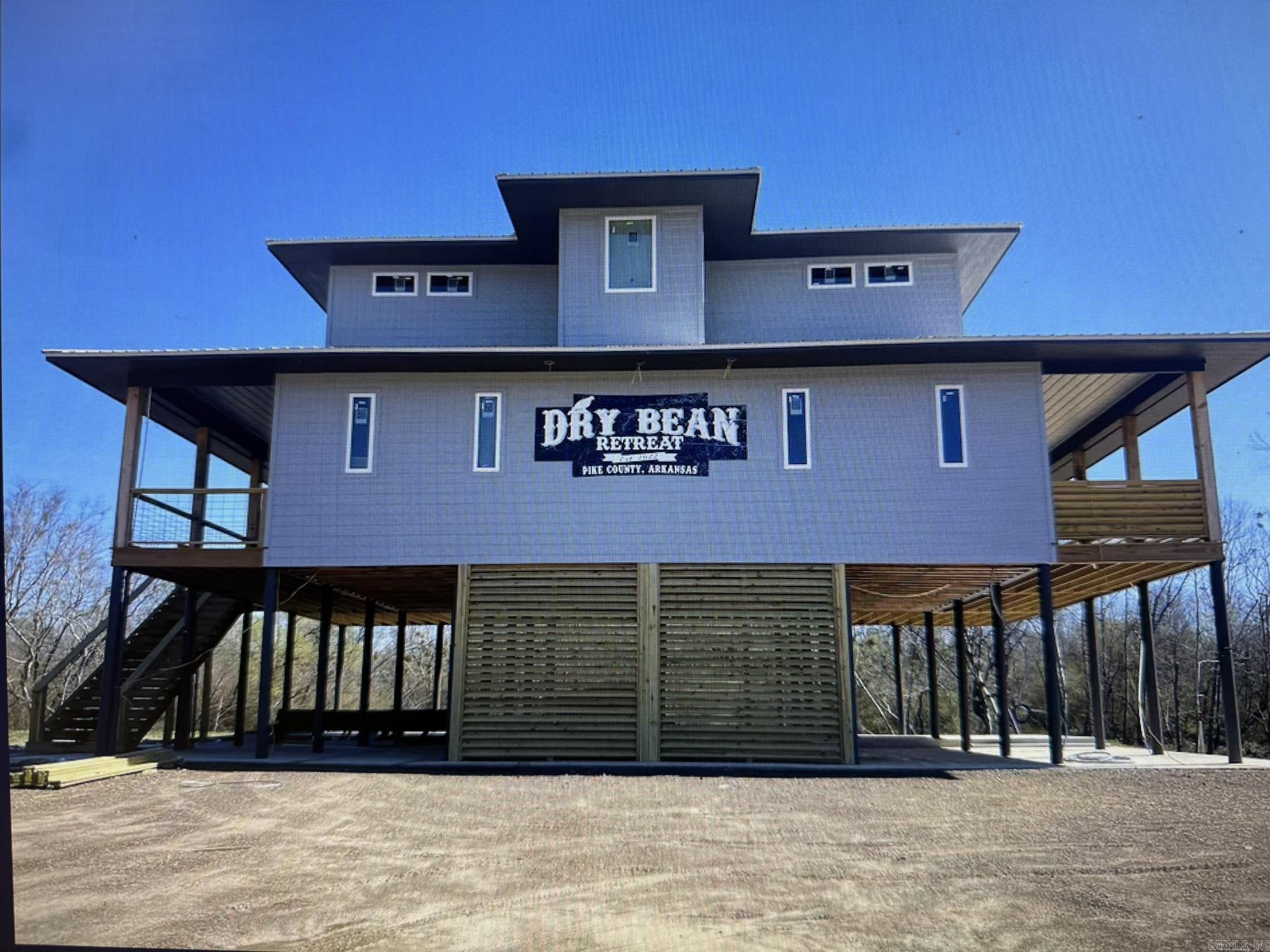 Arrowhead Island Subdivision, Little Missouri River front property, offers a custom built home aka: "Dry Bean" VRBO rental property with a 9.8/10 guest rating and current booking dates that can transfer to new owner.  The possibilities are endless with this river front property including: trout fishing, exploring, canoeing, or rafting, minutes from area amenities including: the Crater of Diamond State Park and Lake Greeson, this home is fully furnished and turn key ready.  This home offers a master suite and additional bedroom and full bath on the main floor, 2 additional bedrooms and 2 full baths upstairs.  Spacious living room with fireplace, kitchen with island bar and dining area, laundry closet with stackable washer/dryer and extra storage.  Large wrap around entertaining deck w/exceptional view of the river. If you are looking to relax and unwind or set out on an adventure, this river front property offers it all.  Contact our office for more details or to schedule a private tour.