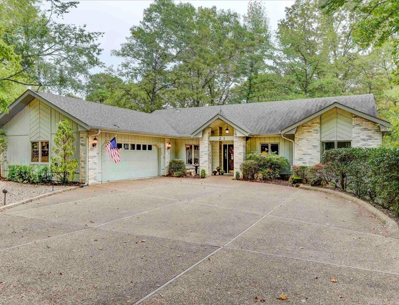 Welcome to your lakeside retreat on Lake Cortez in Hot Springs Village! This charming 1,991 sq ft 3BR 2.5 BA home offers serene living with breathtaking views of nature and peaceful lake views. Step inside to a bright, open floor plan with modern upgrades, including stainless steel appliances in the kitchen. New HVAC and Water Heater in 2024. The spacious living areas are perfect for entertaining or unwinding while enjoying the tranquil surroundings. For the hobbyist, the oversized 2-car garage is large enough for golf cart and features a built-in workbench, and the large workshop on the lower level provides ample space for projects and storage. Outside, you'll find a covered boat dock—ideal for enjoying Lake Cortez’s recreational opportunities right from your doorstep. Whether you’re boating, fishing, or simply soaking in the beauty of the outdoors, this home offers the perfect blend of comfort and nature. Don’t miss your chance to own this hidden gem, where lake life and peaceful living await! Taxes are before Homestead Credit