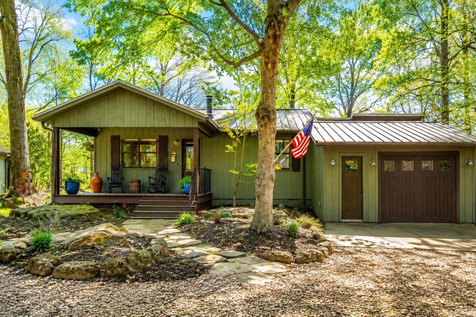 Riverfront Living on the Little Red River!  Beautifully remodeled in 2019 by Stone Custom Builders, this 2,449 sq. ft. riverfront home offers 3 bedroom, 3 bathrooms, an office, and a spacious primary en suite addition featuring a vaulted ceiling, river-inspired shower, and large walk-in closet.  Hardwood floors run throughout, while picture windows across the back of the home showcase stunning river views. Enjoy a screened porch spanning the length of the home and an expansive deck overlooking the water.  The landscaped backyard features rock work for beauty and erosion protection, and a new dock is scheduled for installation in mid-July!  Additional amenities include a separate shop, covered boat storage, hot tub, indoor storage area, and underground storm cellar.  Updates/upgrades to River House Rock work 70k New electrical box outside w/built in surge protector Dehumidifier under house New HVAC New metal roof  LED lights throughout  Primary suite added Primary bath heated bathroom floors Porches (front and back) All screened in porches  Outdoor fans  Outdoor lighting  Fish, kayak, or simply relax from your own backyard and enjoy all that Little Red River living has to offer!