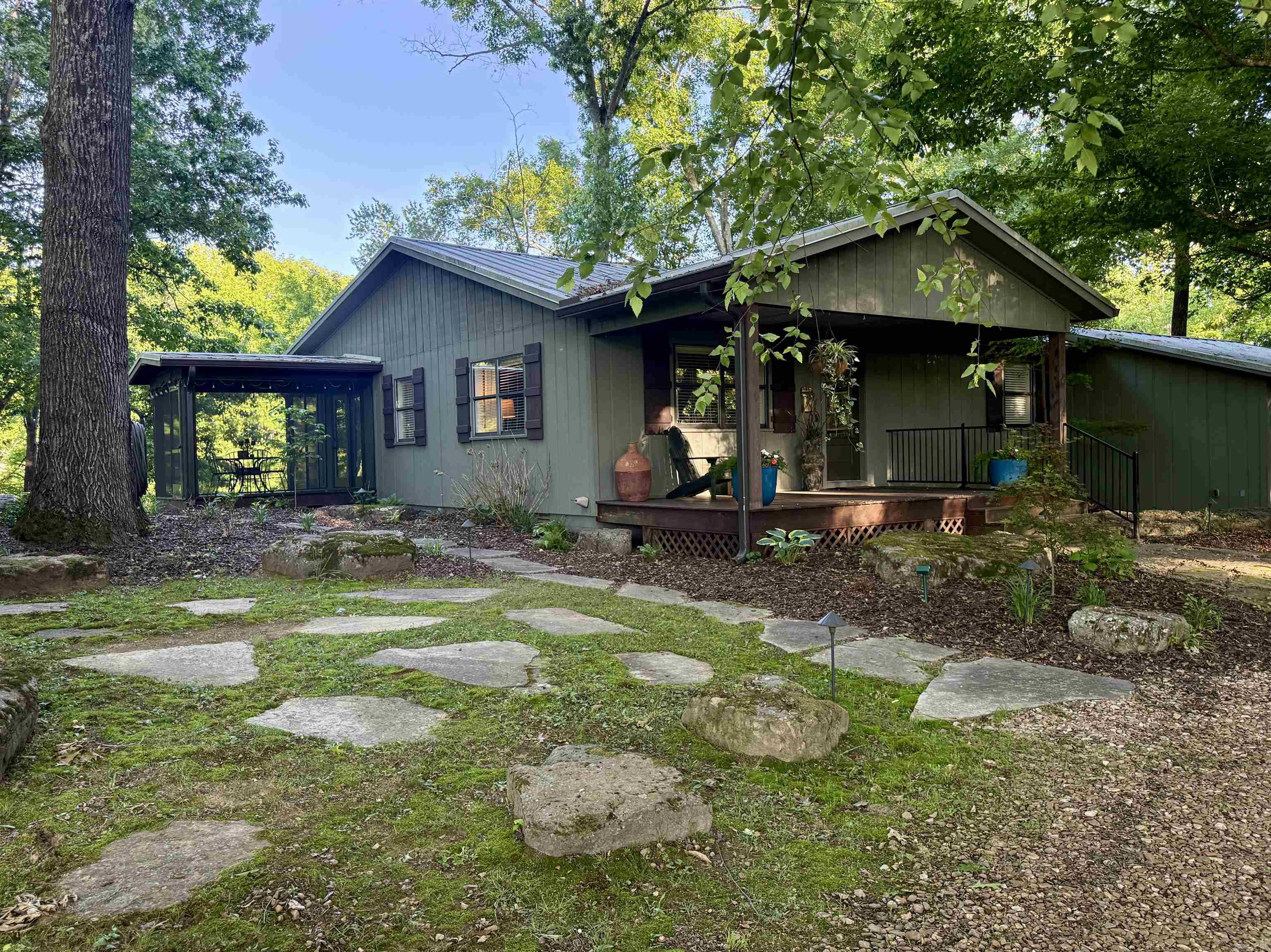 Nestled along the Little Red River, this charming home offers the perfect blend of character, comfort, and thoughtful updates. Featuring 2,449 sq ft, 3 bedrooms, 3 bathrooms, and a dedicated office, this home provides versatile living.  Hardwood floors run throughout, and a recently added primary suite features a vaulted bedroom, river-inspired shower, and large walk-in closet. Picture windows span the back of the home, filling the space with natural light and capturing beautiful river views.  A screened-in porch stretches across the entire back of the home, along with a large deck extending over the river perfect for relaxing or entertaining. The backyard includes rock work designed for beauty and erosion prevention.  Additional features include a hot tub, indoor storage area, separate shop, and underground storm cellar. Ideal for full-time living or a weekend getaway.