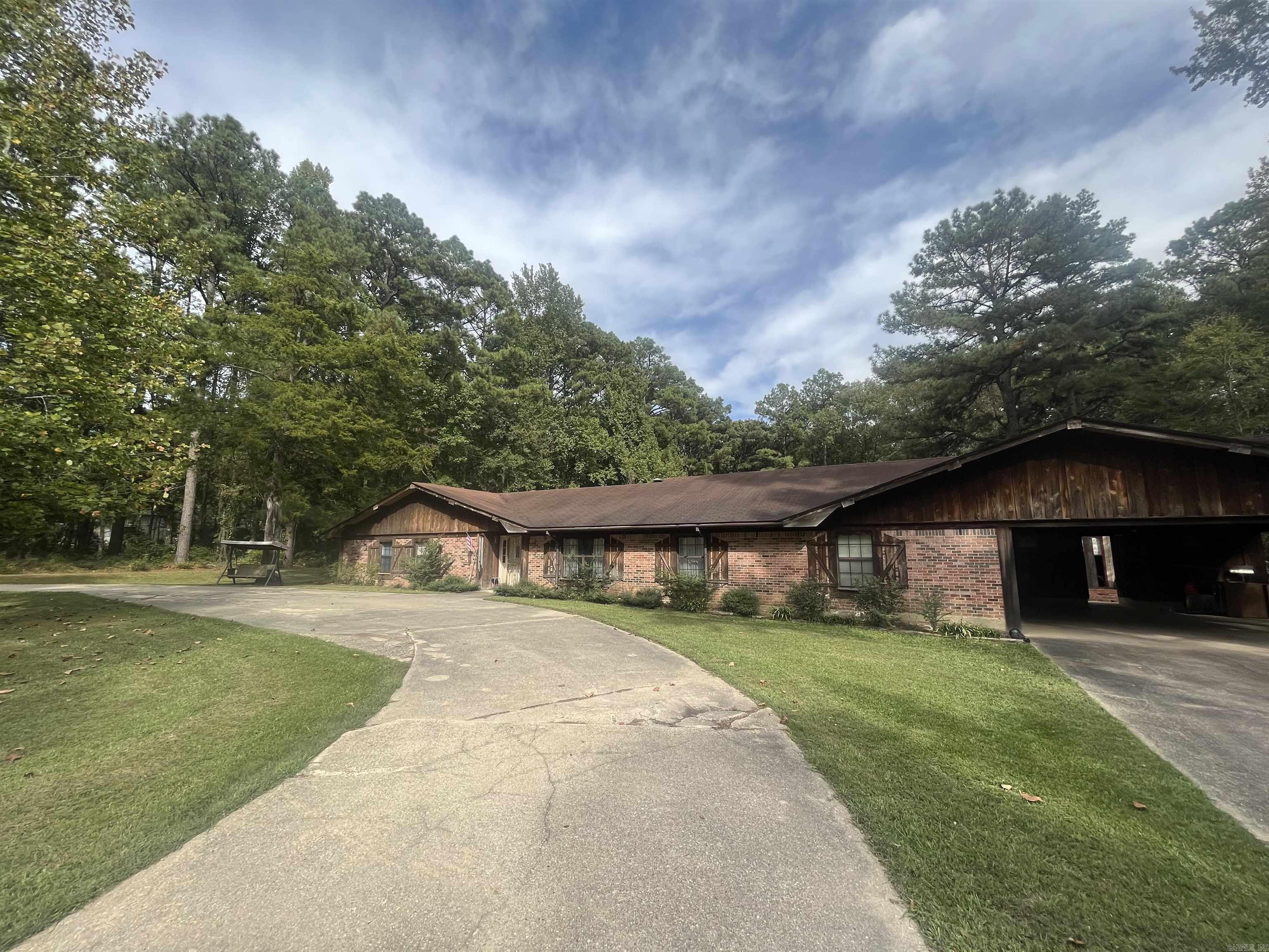 Located on 2 acres of beautifully landscaped land, this home provides the peace and quiet you've been looking for. Wake up to the sight of deer, wildlife, and trees outside your window. The interior of this home is generously proportioned, offering ample space for living and entertaining. Large windows throughout the house invite abundant natural light, creating a warm and inviting atmosphere.  In addition, a large shop which could be used as a workshop, studio, or storage area. The spacious backyard is perfect to host barbecues, create your own vegetable garden, or just enjoy the tranquil beauty. This home is conveniently located near downtown Monticello offering easy access to schools, shopping, dining, and recreational facilities. Enjoy the best of both worlds – peaceful country living and amenities within reach. Schedule a showing today and experience southern living at its best.