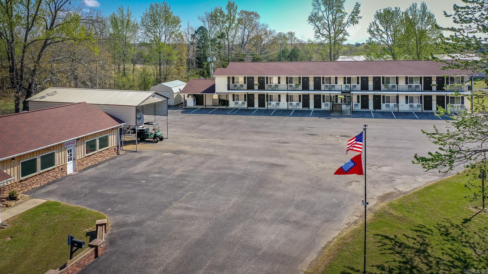 This is a rare opportunity to own a thriving, turnkey hospitality property in the heart of Greers Ferry. Ideally located between The Narrows Bridge and The Edgemont Bridge, this well-established 16-room motel attracts steady business from fishermen, boaters, and lake travelers who return for its convenience and proximity to the water. Shiloh Marina, Lacey’s Marina, and Devil’s Fork Park Boat Ramp are just minutes away. The motel offers approximately 5,424 sq ft of updated guest space, including 2 king rooms and 14 double queen rooms. All rooms have been refreshed, including energy-efficient LED lighting. Furnishings, appliances, and motel equipment convey. Recent upgrades include new tankless gas water heaters installed in 2025. The motel operates primarily on electric, with gas used only for water heaters and two commercial dryers, and has its own septic system. A separate 3BR/2BA home offers approx. 1,560 sq ft, a fenced backyard, major appliances, and a long-term tenant who wishes to stay. A 14x24 storage building and easy boat parking add value. This well-maintained property offers strong income and long-term potential.