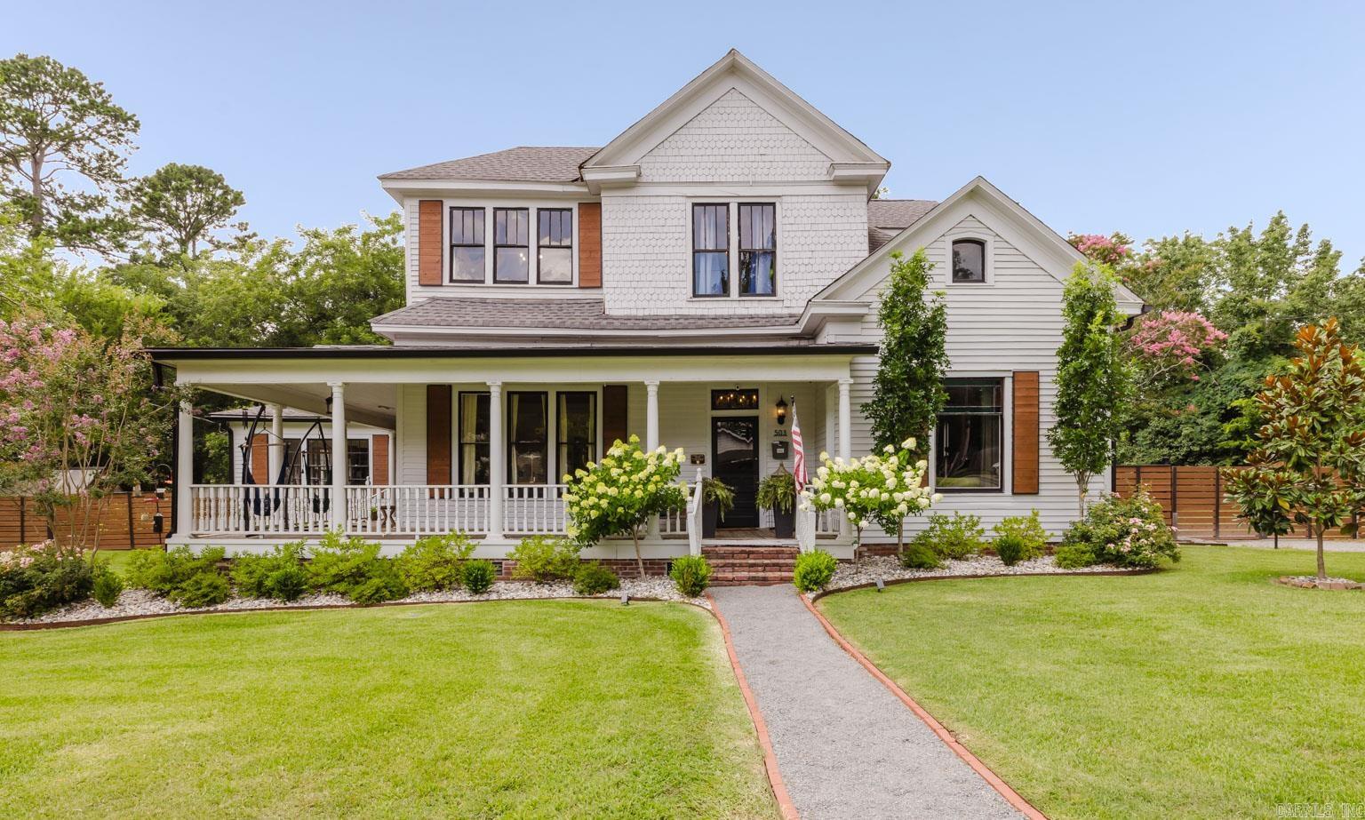 The Bennett House - Listed on the National Register of Historic Places, this stunning Folk Victorian home was built in 1904. 1.36 acres with a garage, shop, & garden! 5 bedrooms, 2.5 bathrooms, a bonus and so much more! Grant eligible for additional updates if desired. Brand New Mini-splits upstairs! Historic features include the original front door, hardware, stained glass window, wood fish scale siding, wraparound porch, single hung and transom windows, original doors, knobs, staircase, flooring, a brick flu, cast iron sinks and bath tubs. Modern improvements include a fully remodeled kitchen and bathrooms, updated plumbing and electrical, spray foam-insulated attic, moisture barrier with fans & dehumidifiers in crawl space, Central HVAC upstairs, tankless water heater, lighting, sprinkler system, privacy fence, fresh paint, a grand 400-lb cast iron chandelier in the entry and a newly added fireplace. A Guide Book with the home’s rich history and full list of improvements is available on-site and in the documents section for agents. Don’t miss your chance to own this beautifully preserved and enhanced historic gem. ZONED MULTI-FAMILY SO IT COULD BE GREAT FOR AN INVESTMENT TOO!